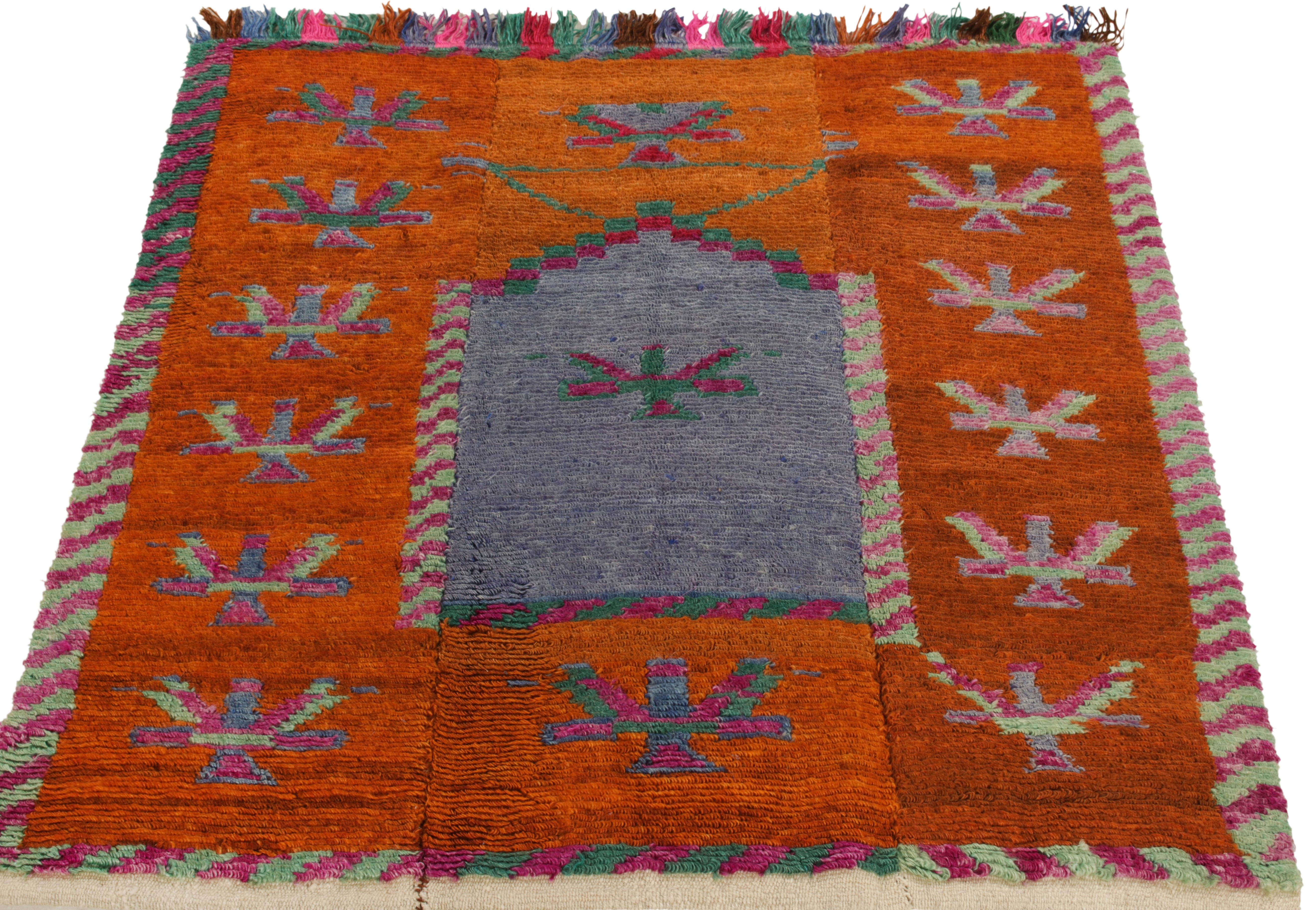 Hand-knotted in wool from Turkey circa 1950-1960, a vintage 4x5 Tulu rug from our Antique & Vintage collection exemplifying the mid-century style—featuring tribal patterns on the field in bright orange, magenta & green complementing the luscious