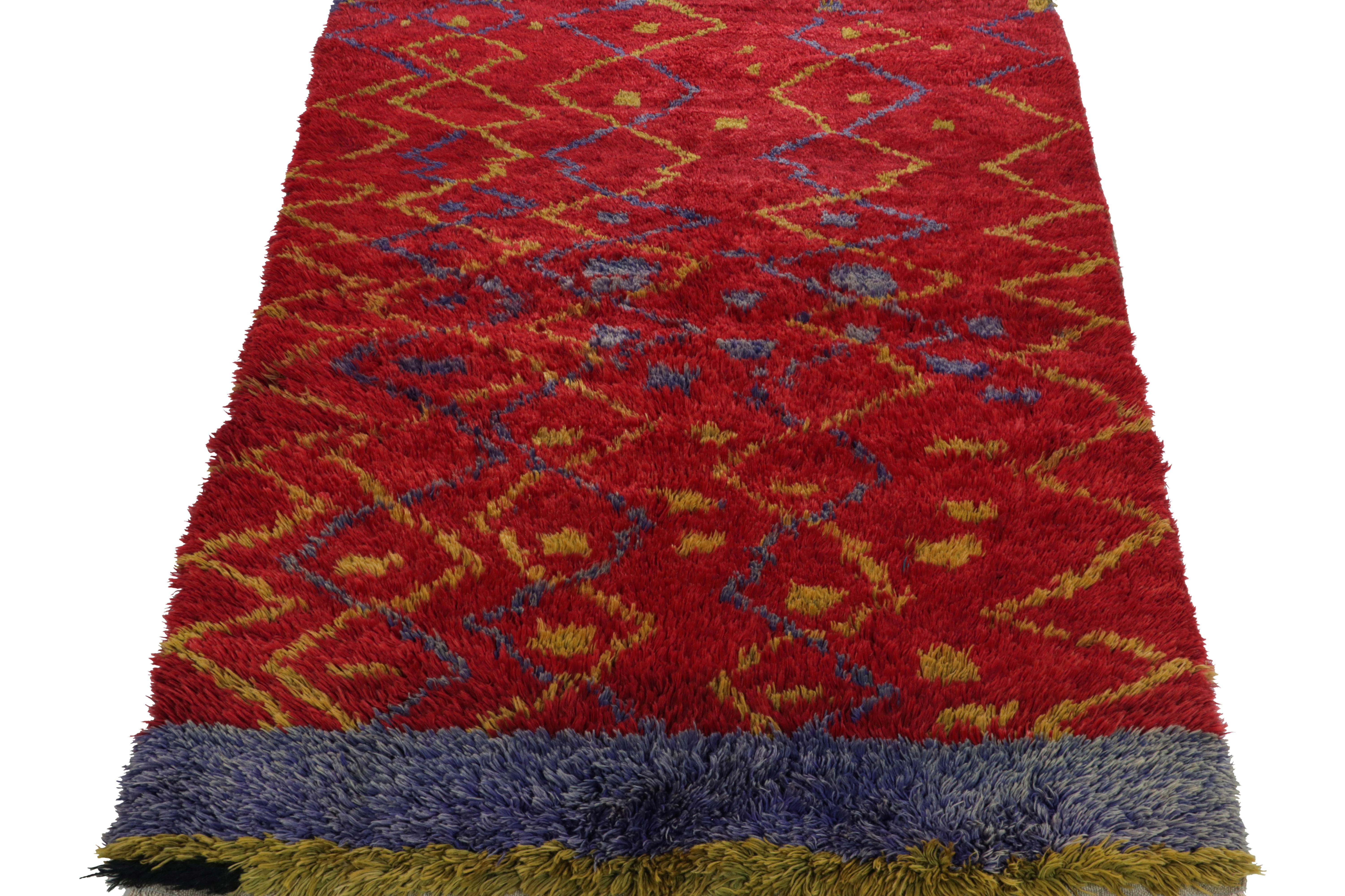 A vintage Tulu runner from Turkey circa 1950-1960, carrying a luscious pile in bright red boldly supporting a defined geometric pattern in green & ink blue tones. The tribal frame enjoys stripes of color on the border further complementing the