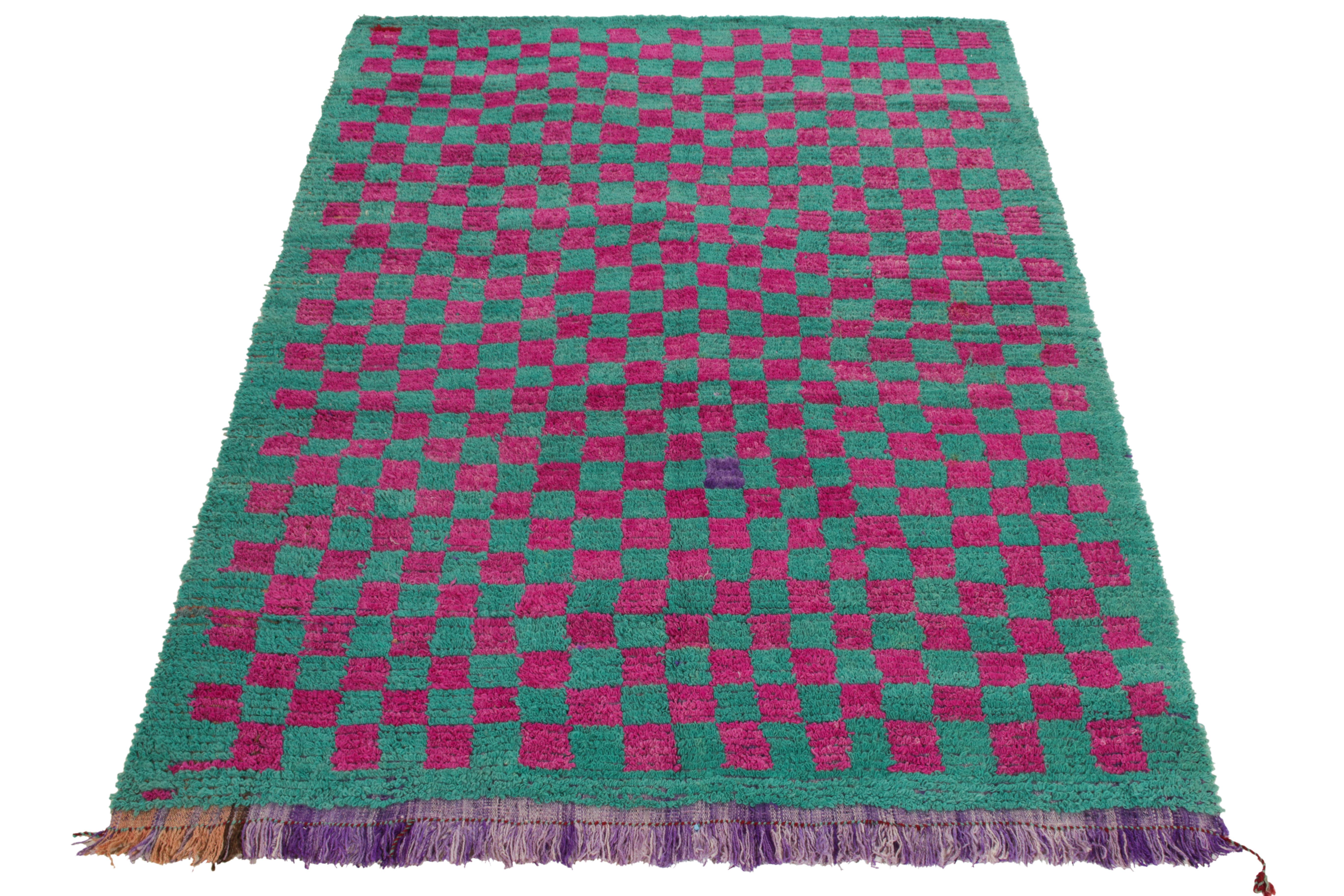 Coming from Turkey circa 1950-1960, this vintage 5 x 7 Tulu rug enjoys a magenta checkered pattern sitting boldly on turquoise for a delicious complement. Hand-knotted in wool, the artistic vision observes gradience in purple & beige tones on the