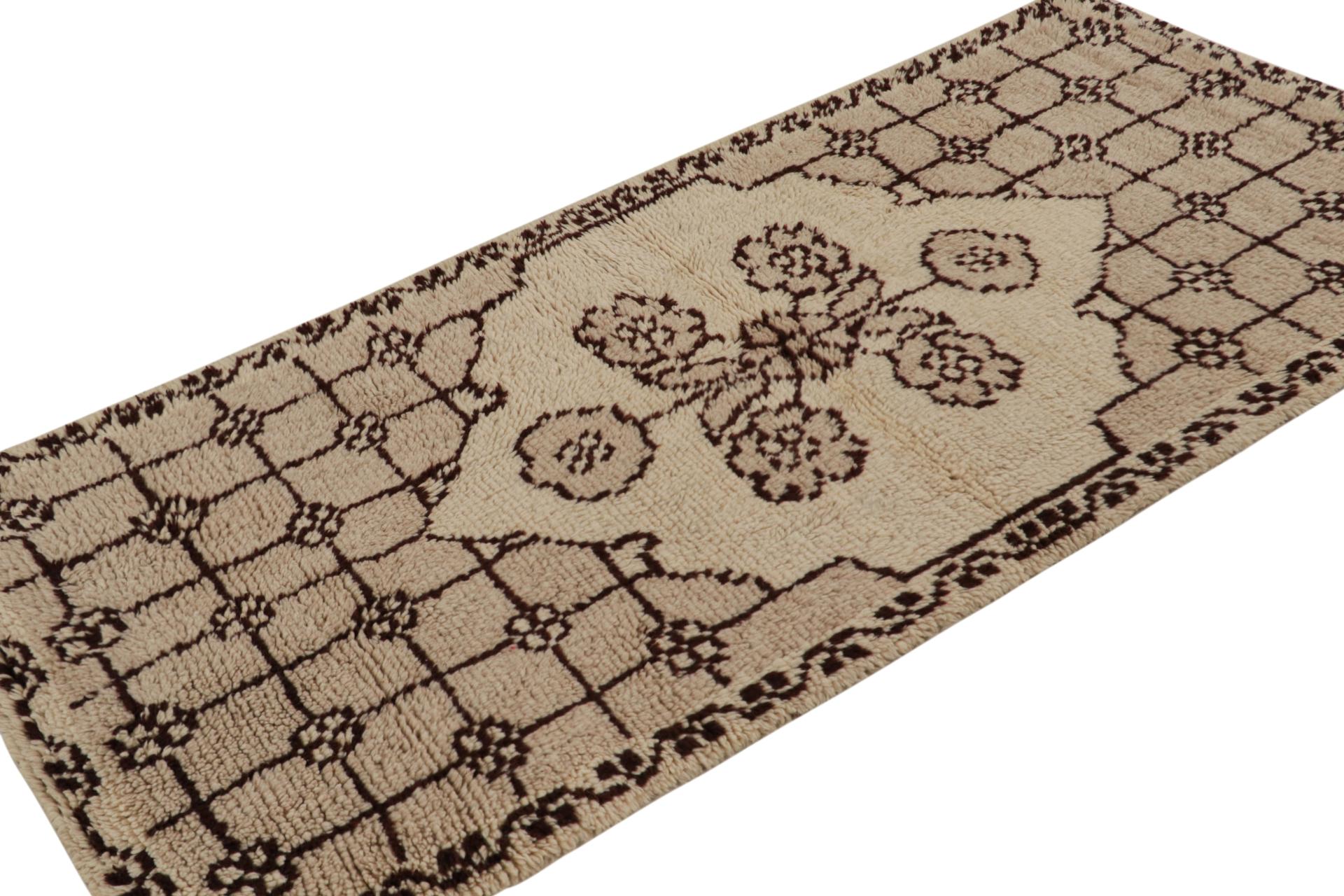 Hand-knotted in wool, this 3x7 vintage Tulu runner rug, circa 1950-1960, is among the family of Tulus with minimalist medallion and floral geometric patterns, as seen in the rich taupe and black tones.  

On the Design: 

Tulus are some of the most