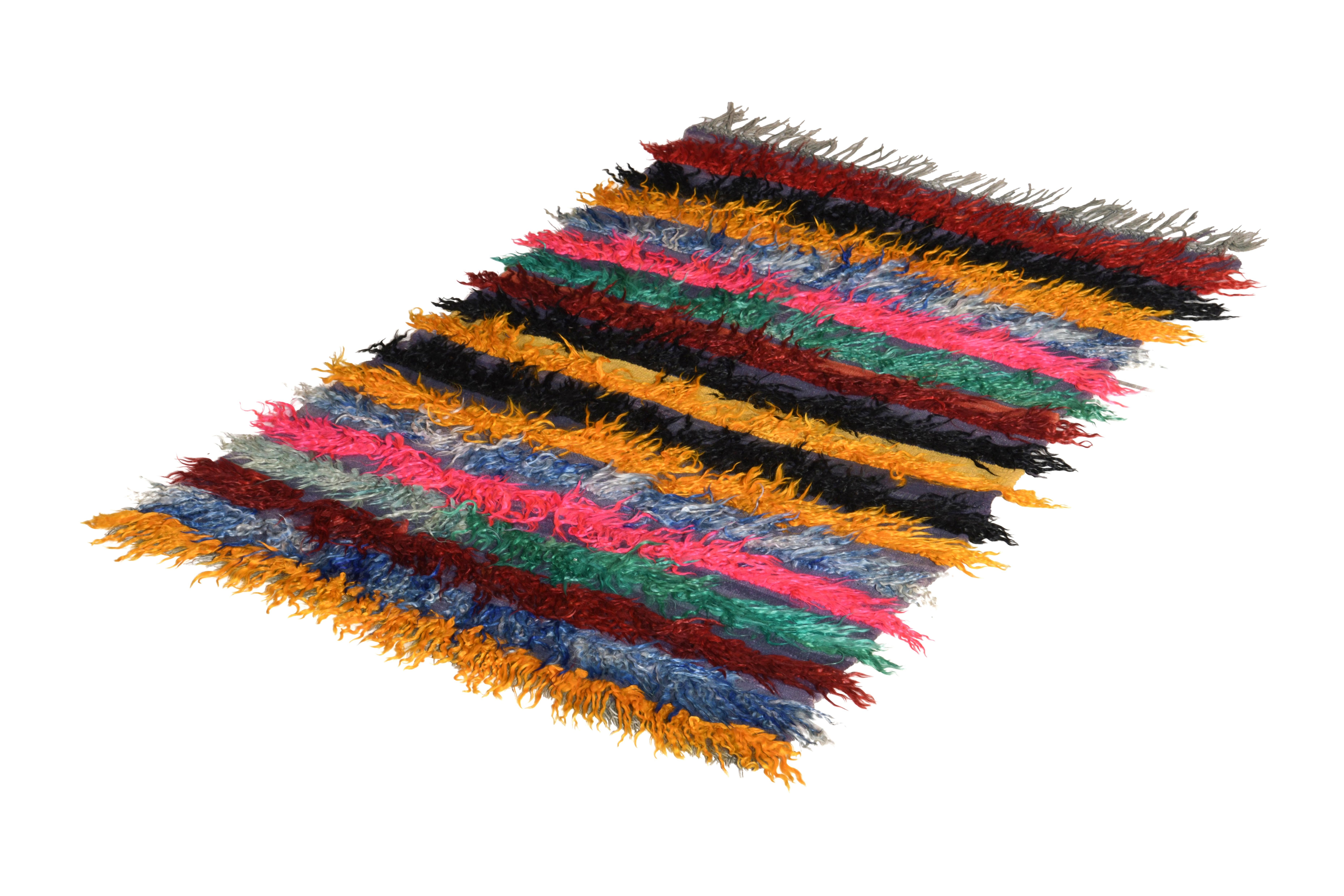 Hand knotted in wool originating from Turkey circa 1950-1960, this vintage rug hails from the midcentury Tulu rug family, known for lively, playful shag rug style and textural approaches like that of this multicolor high-low stripe pattern in 4 x 6.