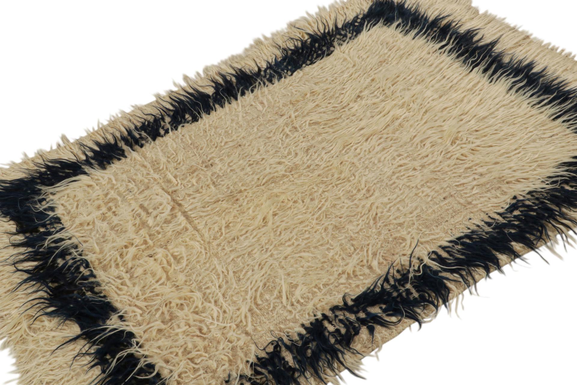 Hand-knotted in wool, this 4x6 vintage Tulu shag rug, circa 1950-1960, is among the family of Tulus with minimalist geometric patterns, as seen in the rich beige neutral tones  

On the Design: 

Tulus are some of the most sought-after high-pile and