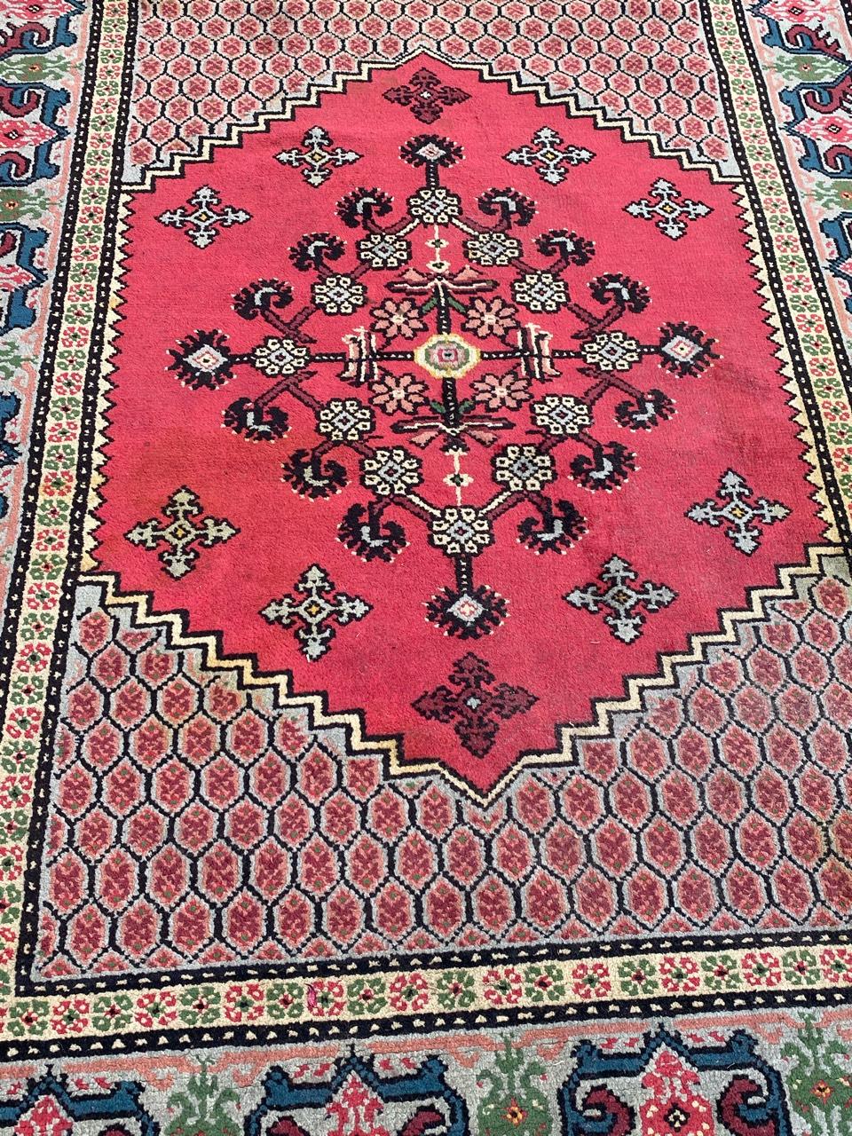 Beautiful late 20th century Tunisian rug with a geometrical design and nice colors with pink, blue, green and purple, entirely hand knotted with wool velvet on cotton foundation.