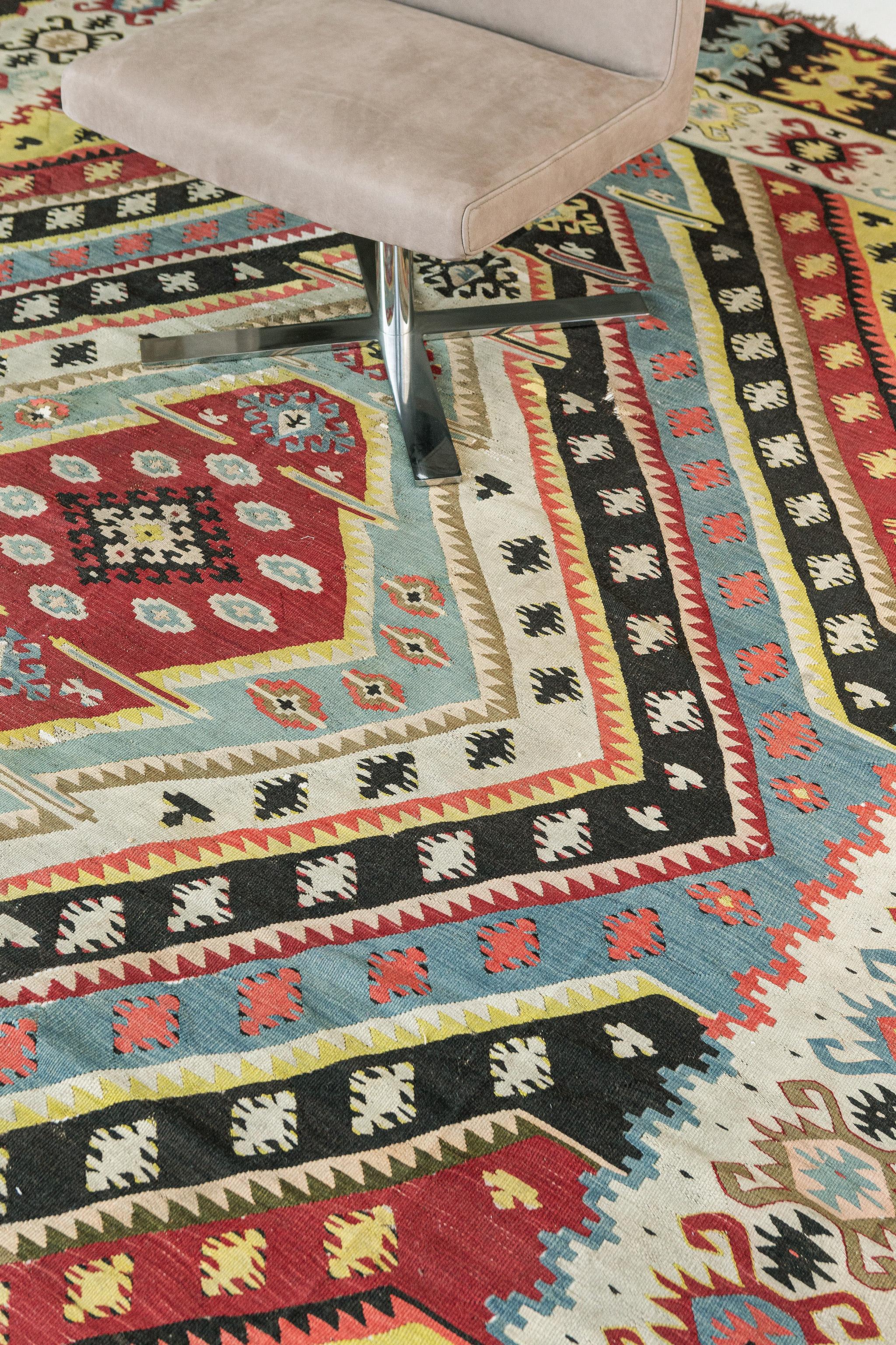 A vibrant and extraordinary vintage Turkish Anatolian rug features Tribal designs that are coupled into diamonds and are also surrounded by lively Anatolian borders. Vintage Turkish Anatolian rugs weave together dyes and colors, motifs, textures,