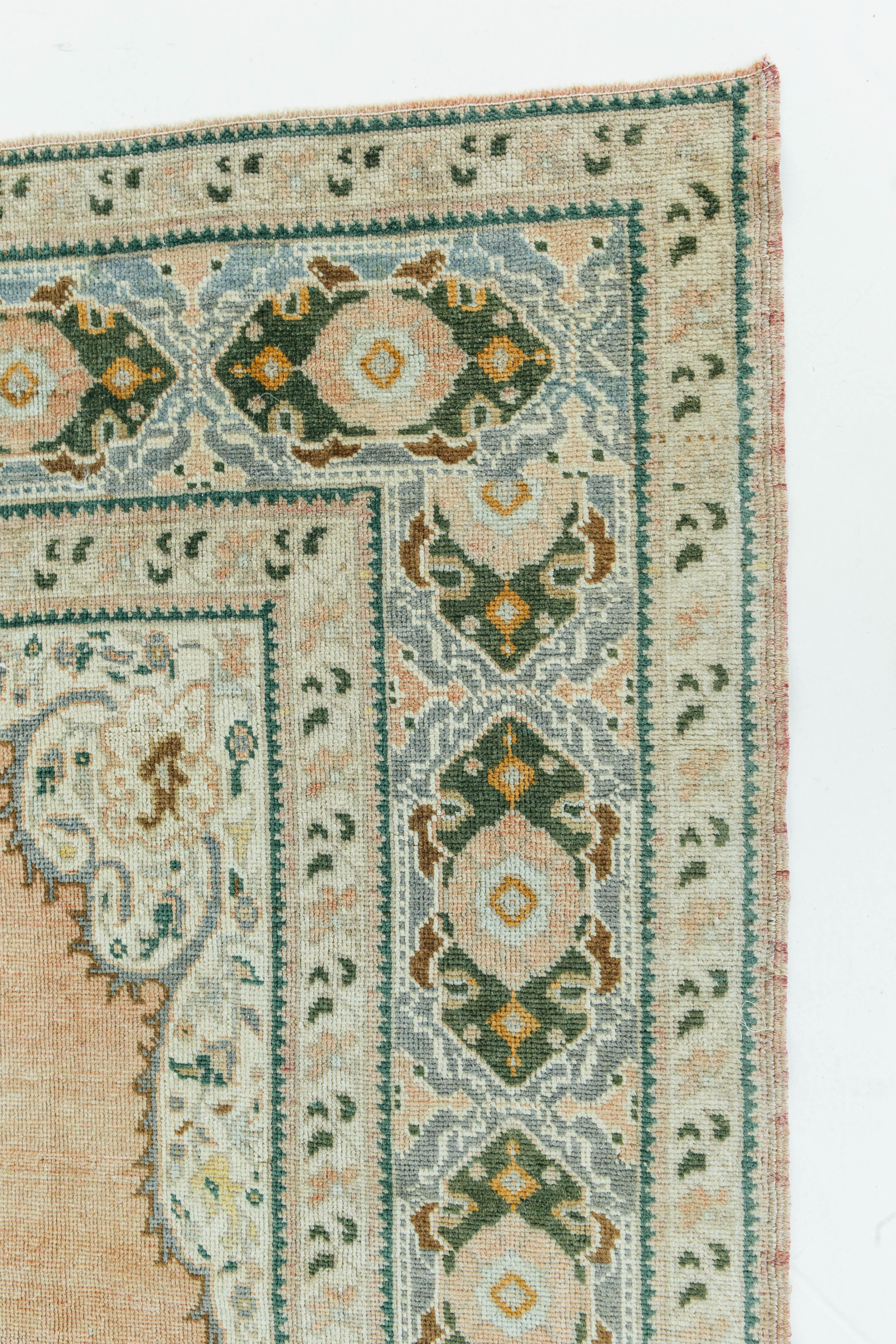 This vintage Turkish Anatolian rug weaves together dyes and colors, motifs, textures and techniques that are popular in Anatolia or Asia Minor. Anatolian rugs are known for their central medallions and symmetrical design. This vintage piece is