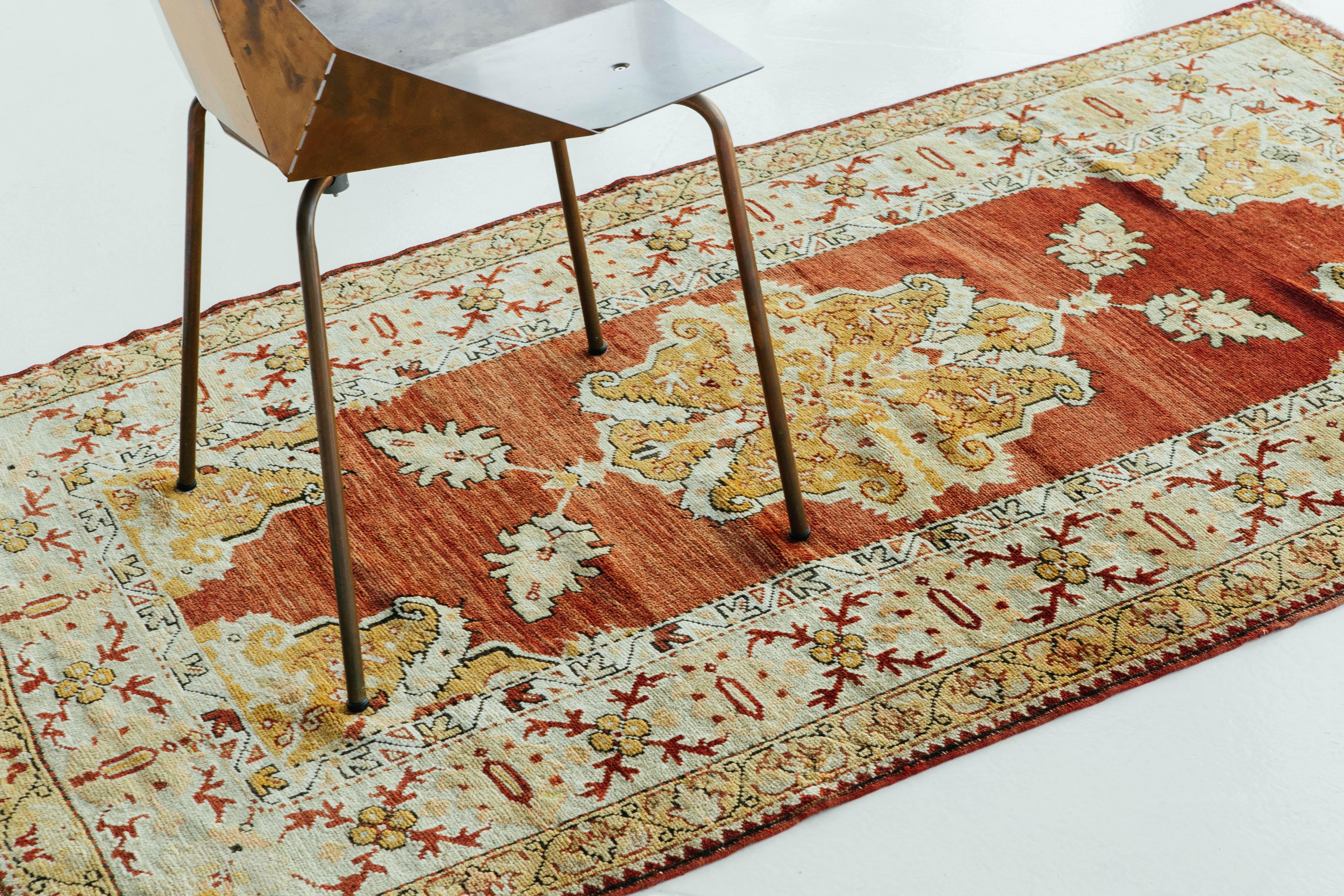 A bold and intricately made vintage Turkish Anatolian rug. Beautiful cherry red and saffron colors make a statement meanwhile the Anatolian signature medallion takes center stage. Vintage Turkish Anatolian rugs weave together dyes and colors,
