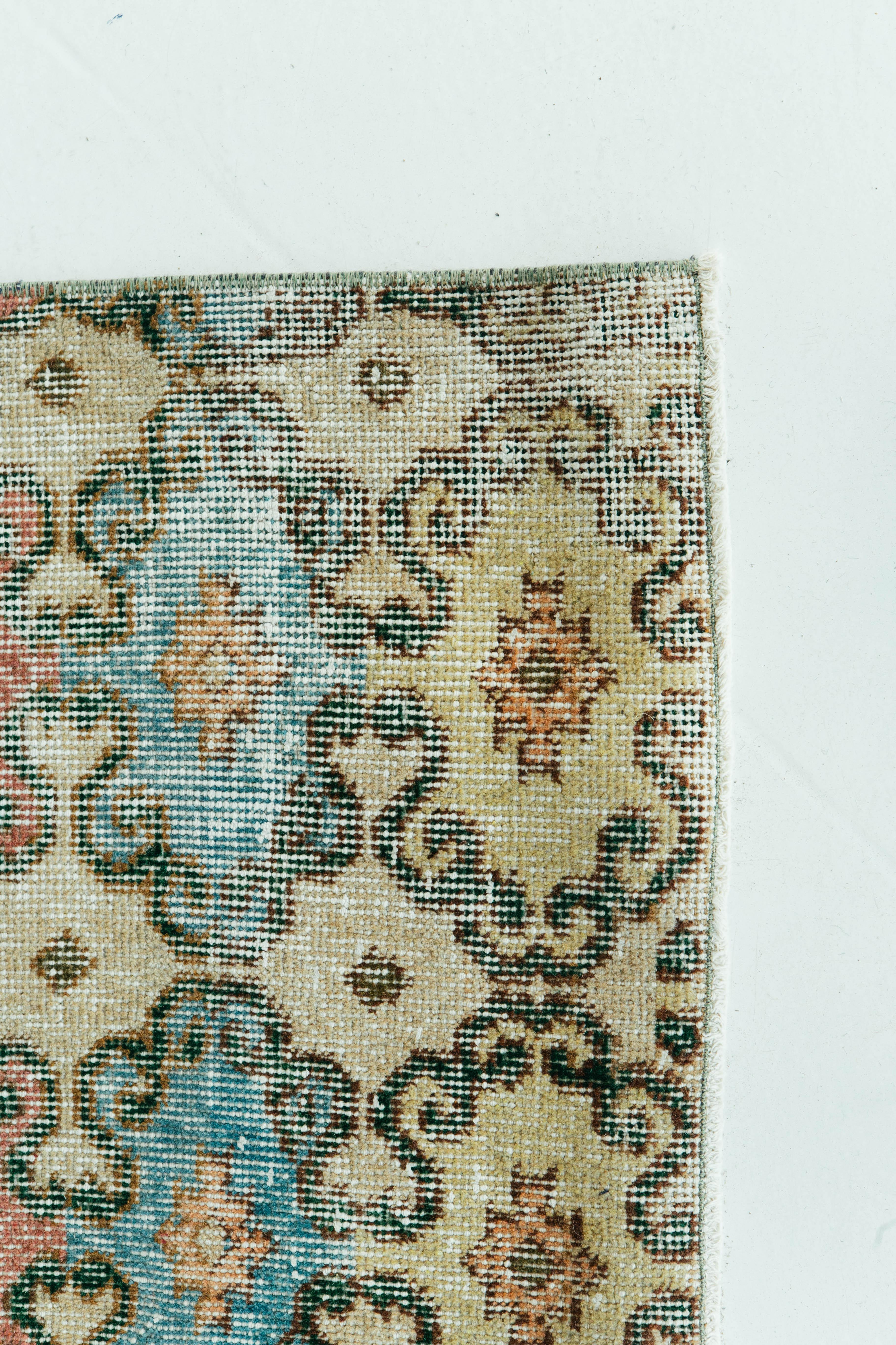 A vintage Turkish Anatolian rug with beautiful florals latticed from top to bottom. Vibrant colors stand out against the ivory field. This one of a kind rug has the perfect vintage feel that weaves together dyes and colours, motifs, textures and