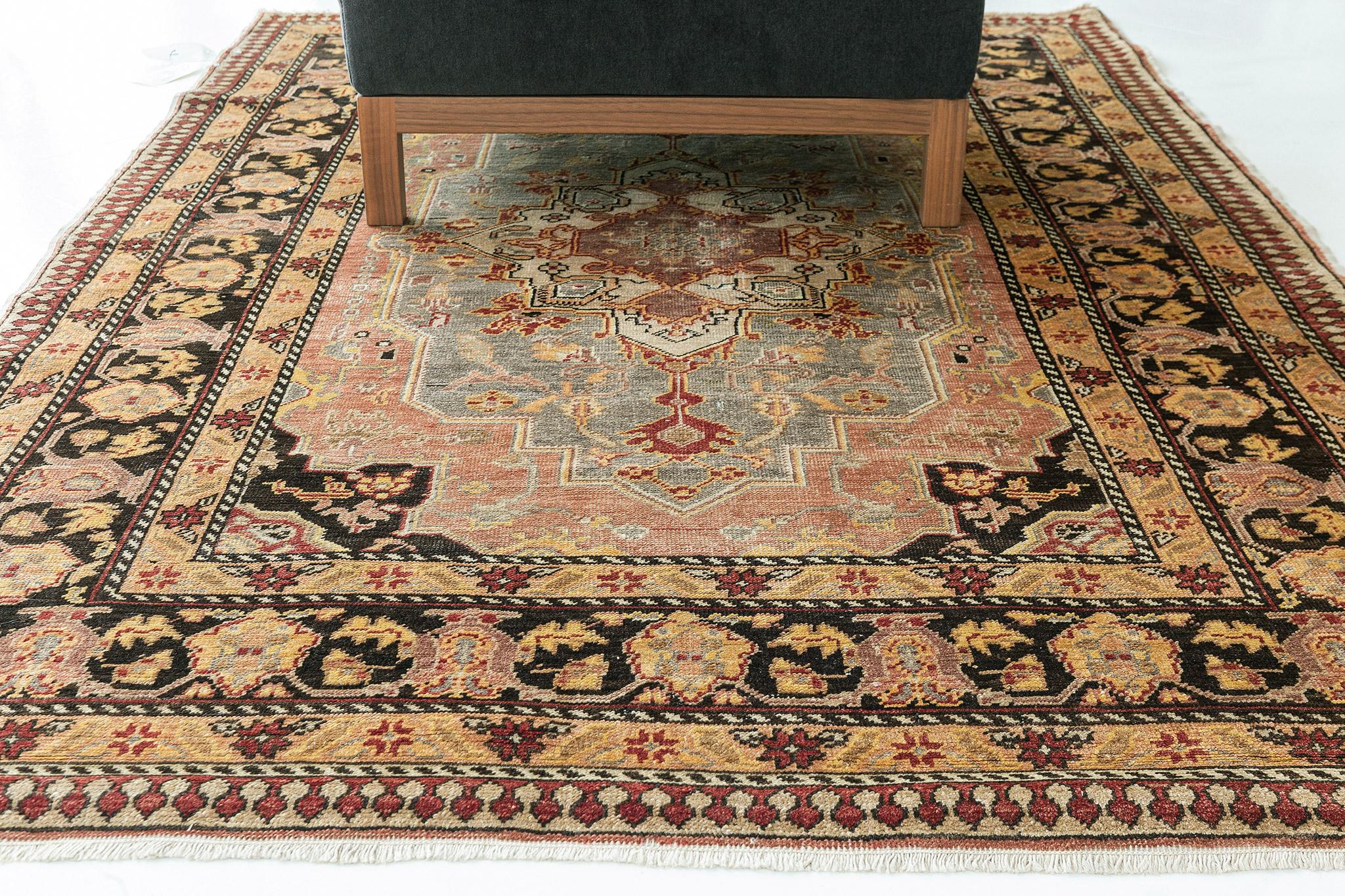 Known as the most genuine in terms of traditional style and motif, this iconic Turkish Anatolian rug features tones of ebony, camel, and terracotta. Meticulously hand-woven details were sophisticated medallions and motifs, repeated all over the