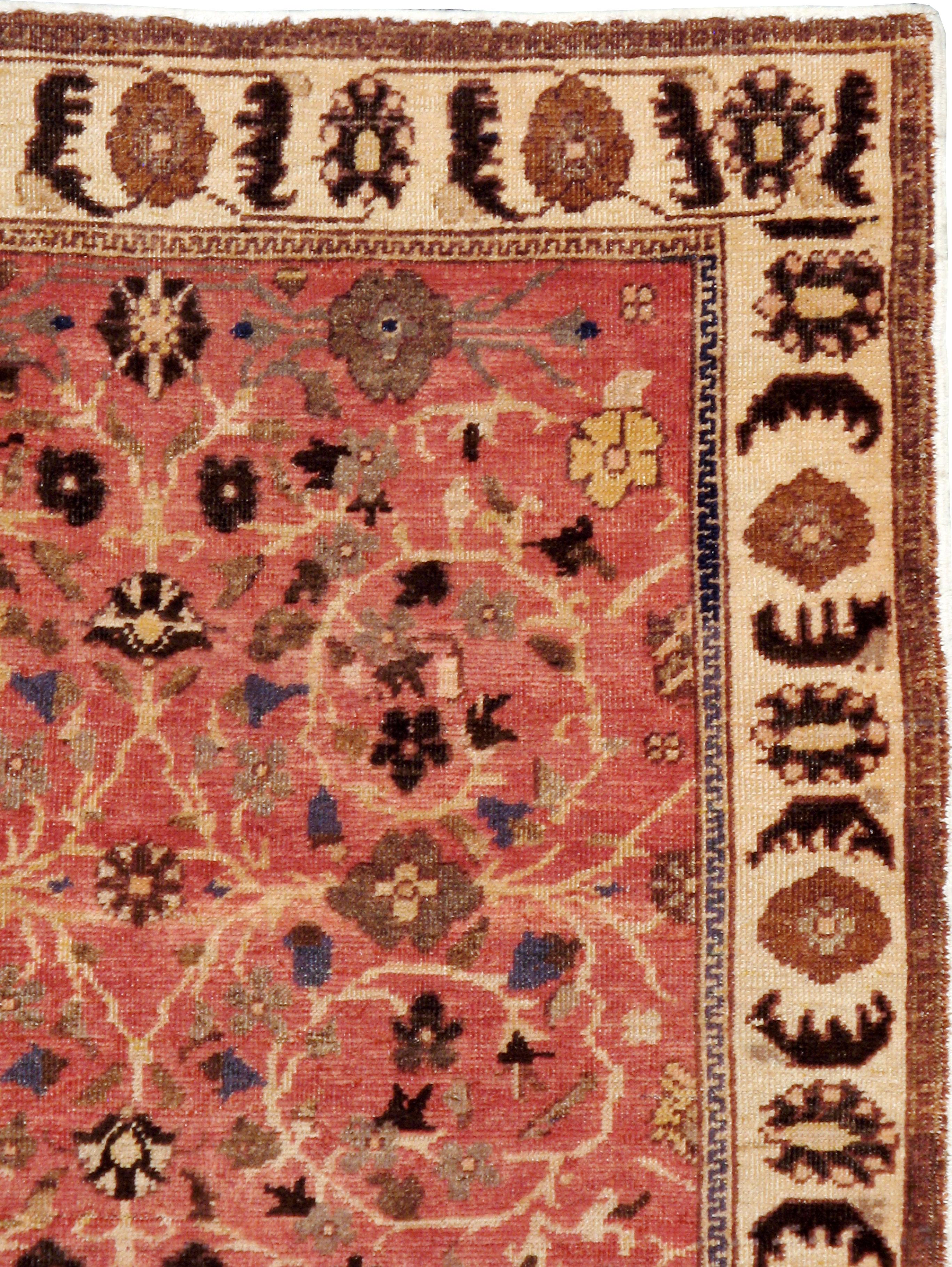 A vintage Turkish Anatolian rug from the mid-20th century. Spiraling foliate arabesques and concave lozenges decorate the dark coral field of this Persianate Turkish gallery rug. The sand border shows rosettes alternating with saz leaves.

Measures: