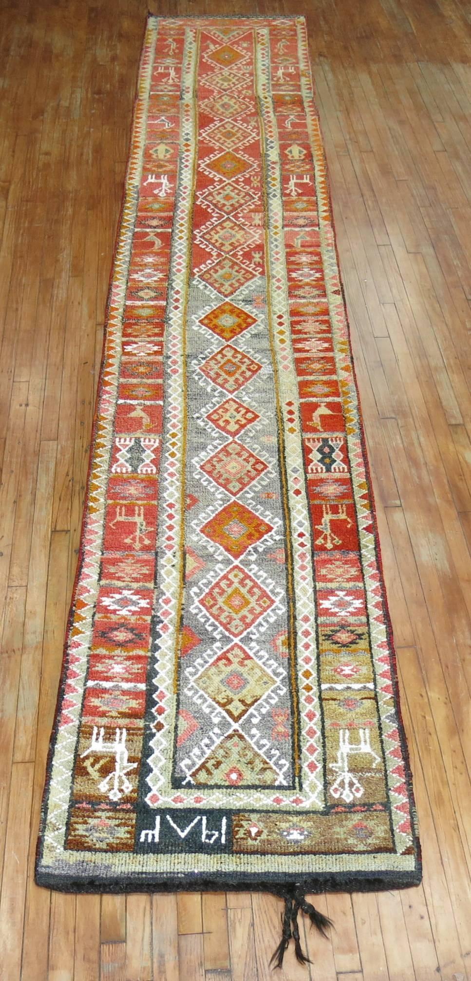 Rare size 20th century Turkish Anatolian runner. We love the one long fringe on one end of the piece giving it added unique element.