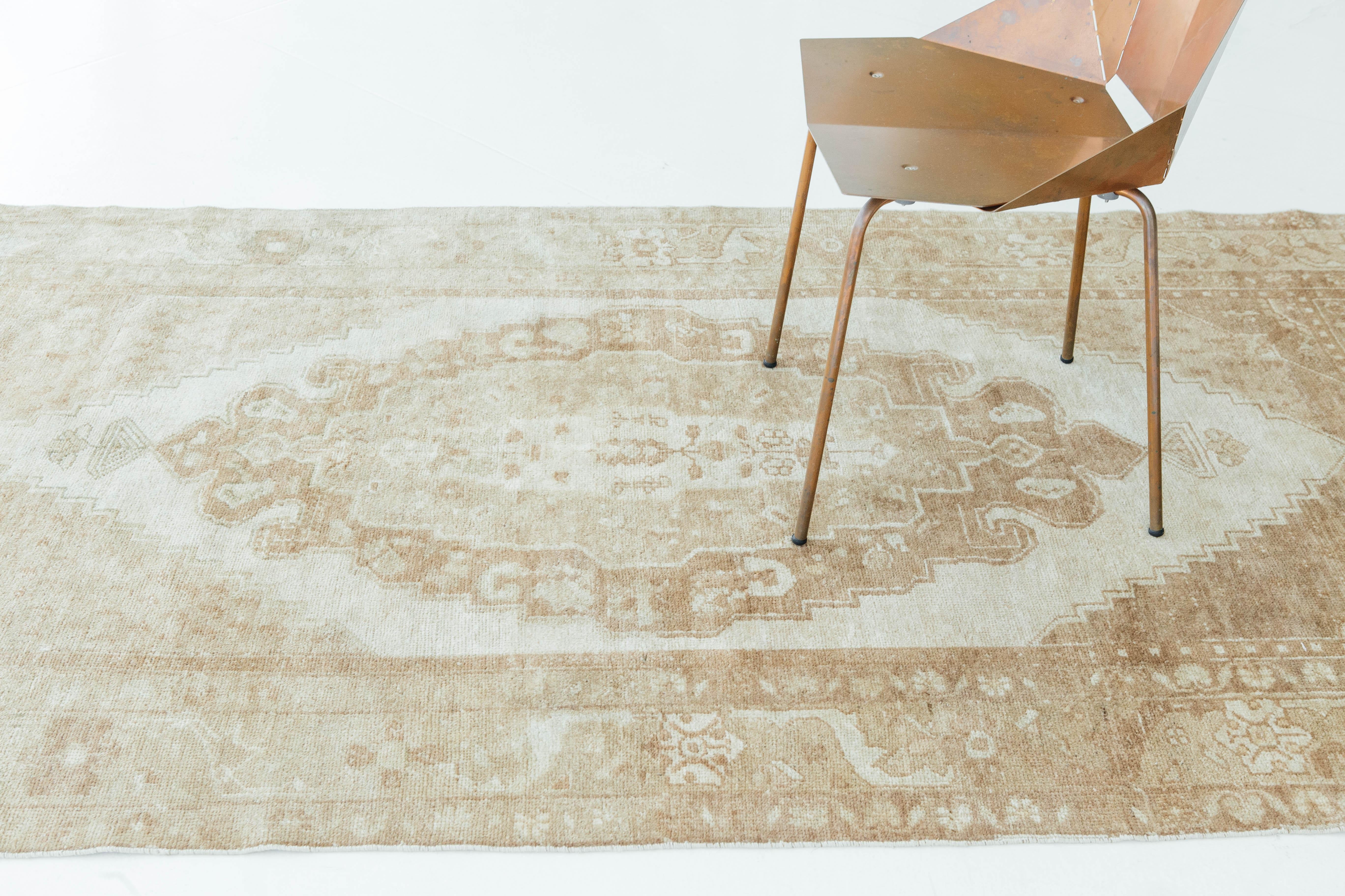 A vintage Turkish Anatolian runner in various hues of tan and ivory. Anatolian rugs are weaved in Anatolia or Asia Minor where rugs are known for their central medallion and symmetrical floral and geometric designs. This vintage runner bring