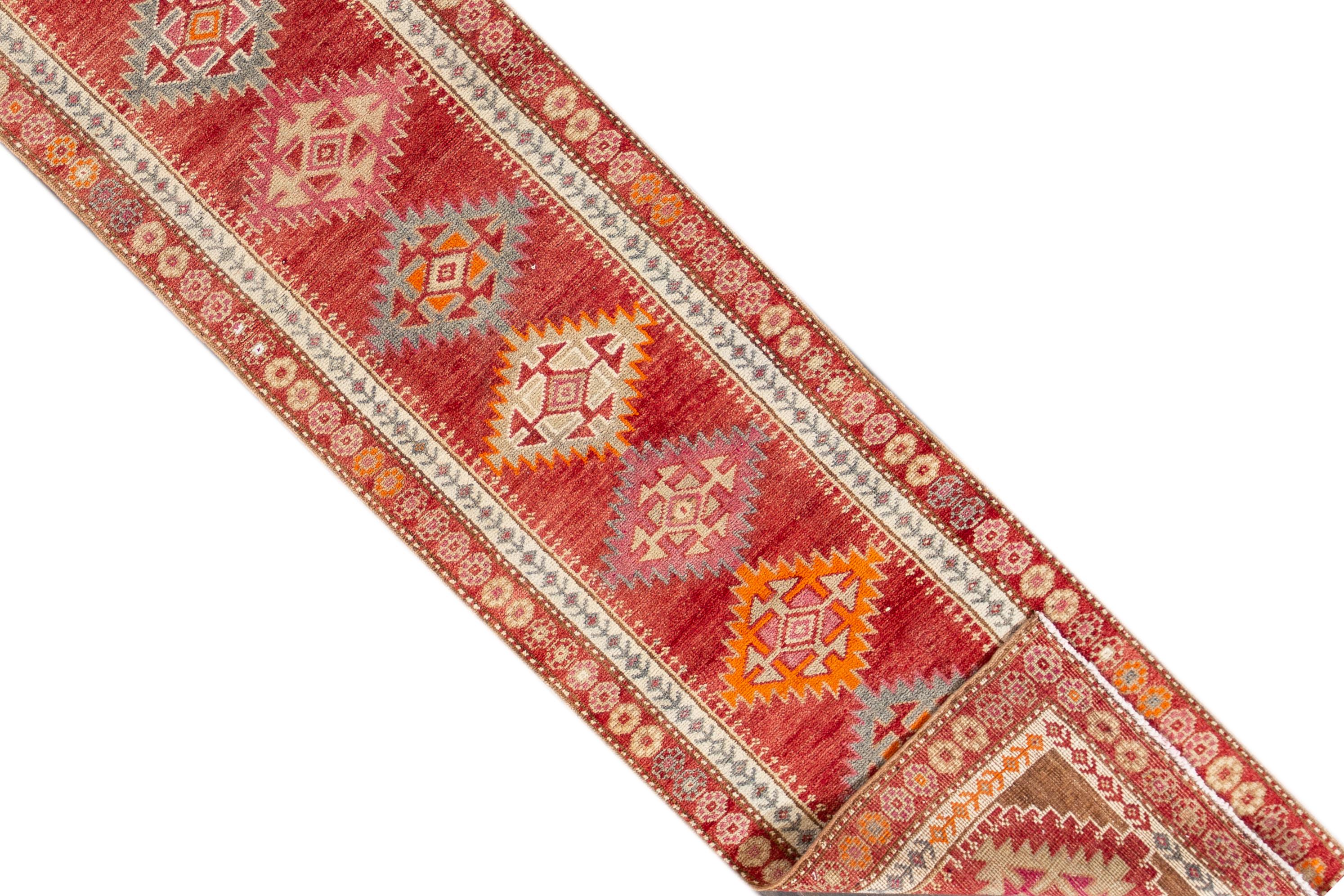A 20th century vintage Turkish Anatolian runner rug with an all-over geometric motif. This rug measures at 2'8