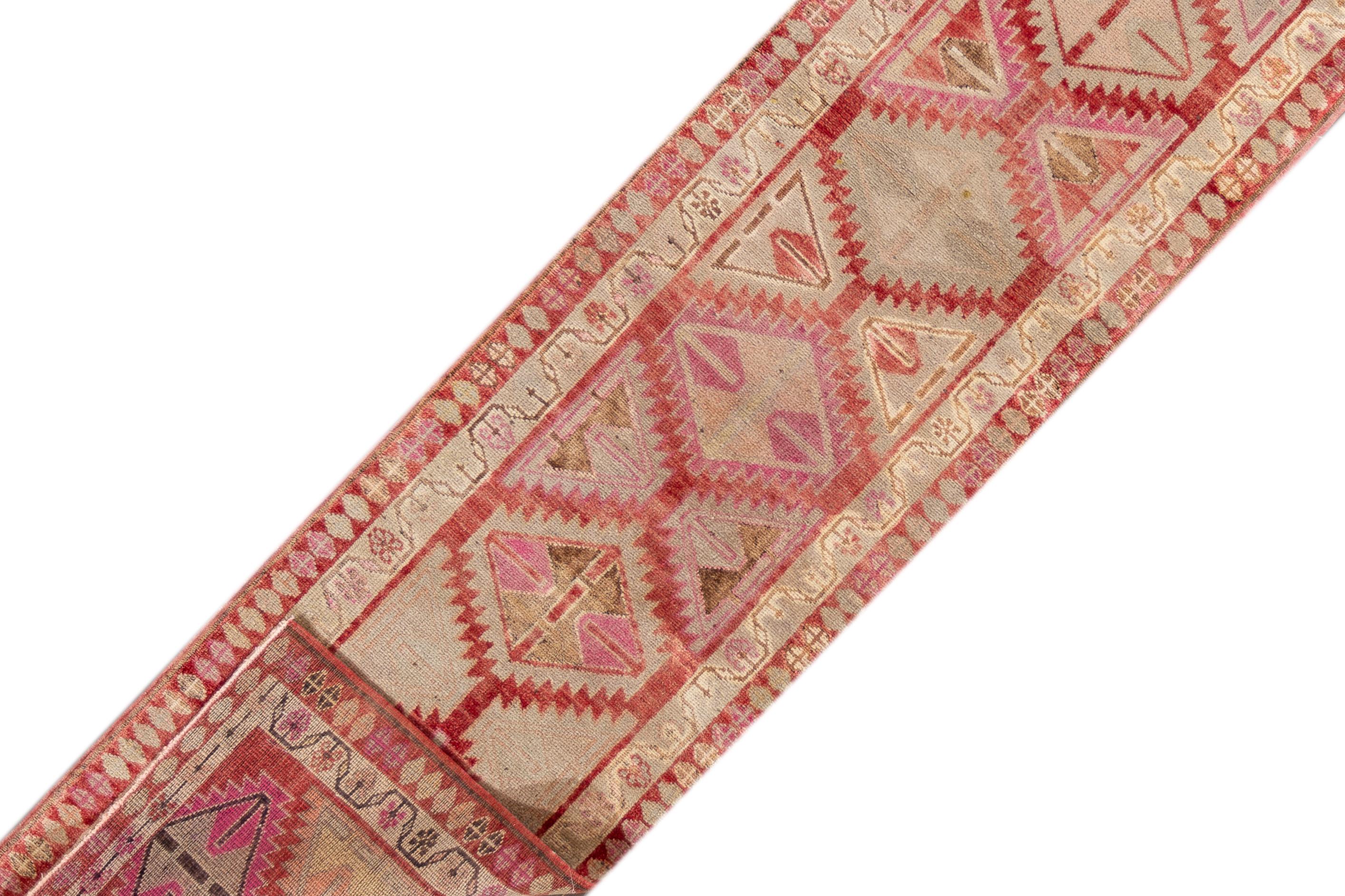 A 20th century vintage Turkish Anatolian runner rug with an all over geometric motif. This rug measures at 2'9