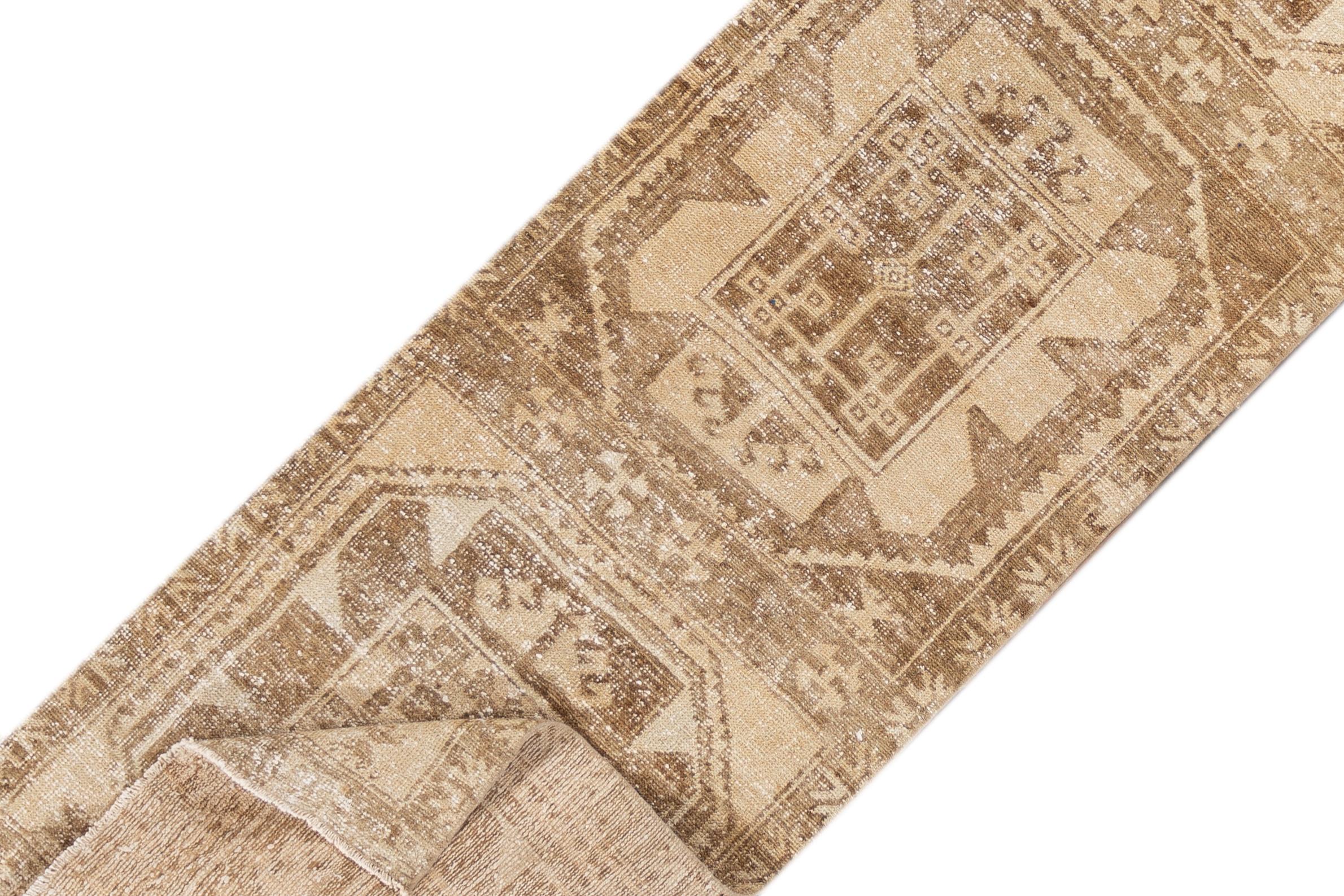 A 20th century vintage Turkish Anatolian runner rug with an all over beige motif. This rug measures at 2'9