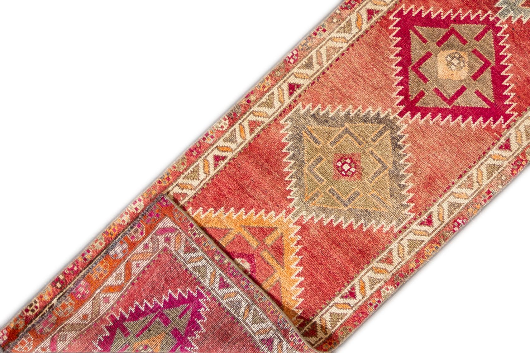 A hand knotted vintage Turkish Anatolian runner with an all-over geometric design. This rug measures 2'7