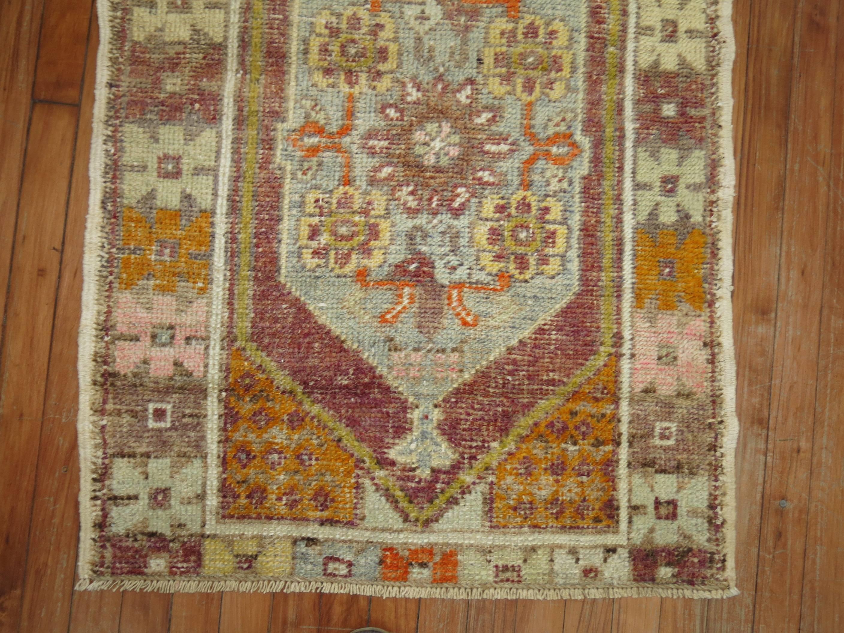 A vintage Turkish Anatolian scatter rug from the middle stages of the 20th century.