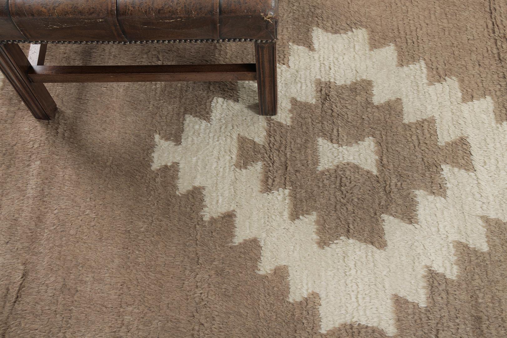 Featuring a gorgeous wool shag of this Vintage Turkish Anatolian Tulu that showcases a muted and captivating earthy tones of ivory and cedar brown. This remarkable rug displays a serrated lozenge medallion gloriously accented in the plush field.