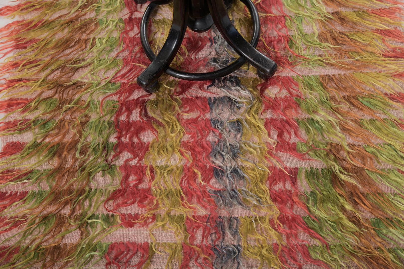 Tulu is a gorgeous wool shag that features amazing layers of variegated tones of rose, green, brown, pink, black, and gold. It augments the stunning scenery and all will be loved by the next generation. Turkish Anatolian rugs weave together dyes and