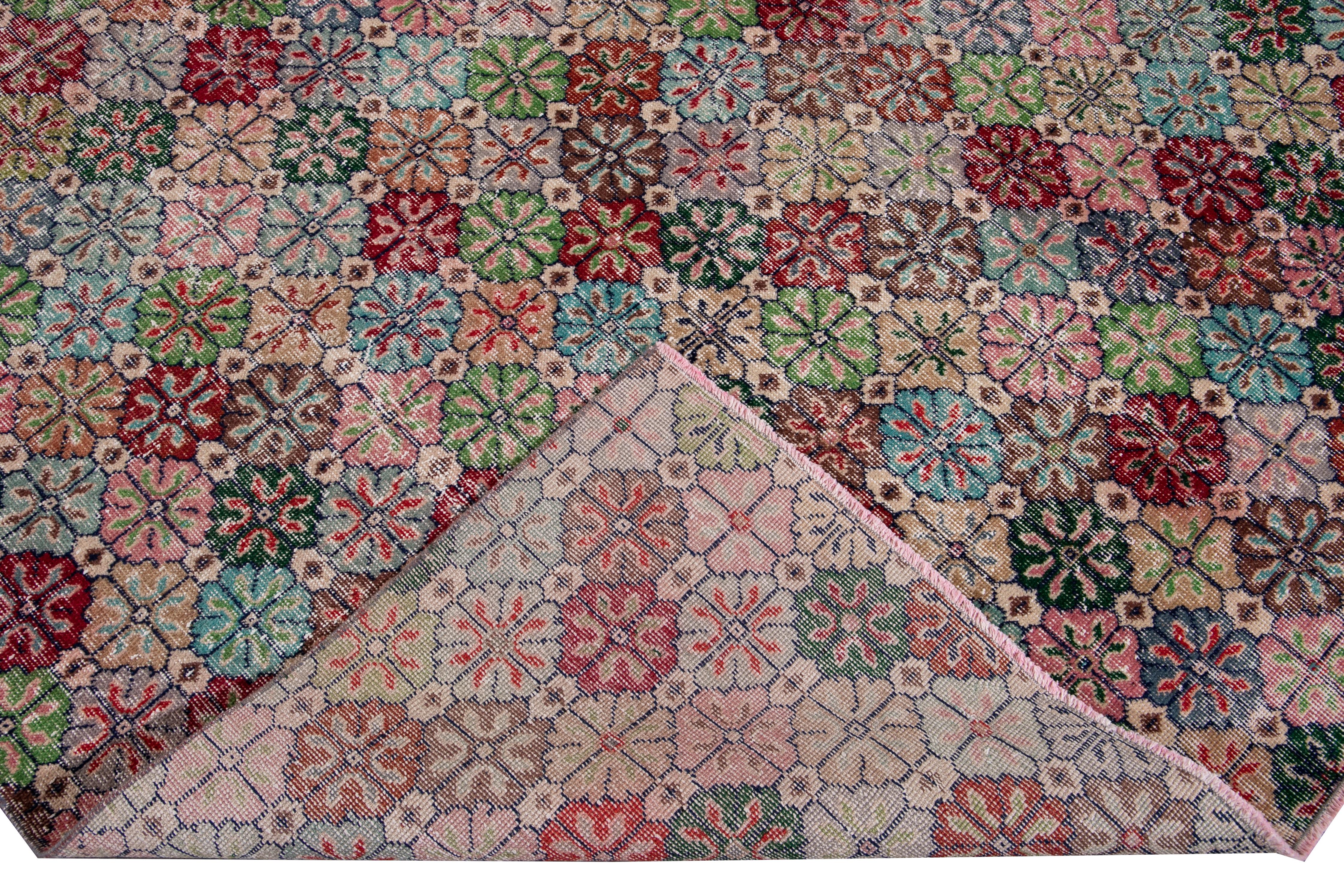 Beautiful vintage Turkish hand-knotted wool rug with a multi-color field. This Turkish rug has a gorgeous all-over geometric floral design.

This rug measures: 6' 10