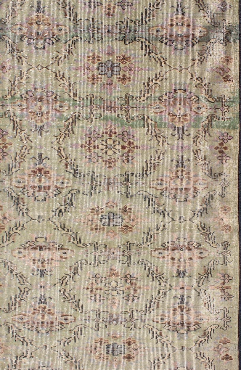Distressed Vintage Turkish Art Deco Rug with All-Over Vining Flowers Design in Green And Lavender. Keivan Woven Arts/ rug/ TU-ERD-4574, country of origin / type: Turkey / Art Deco, circa mid-20th century

Measures: 3'10 x 6'9.

Alive with color and