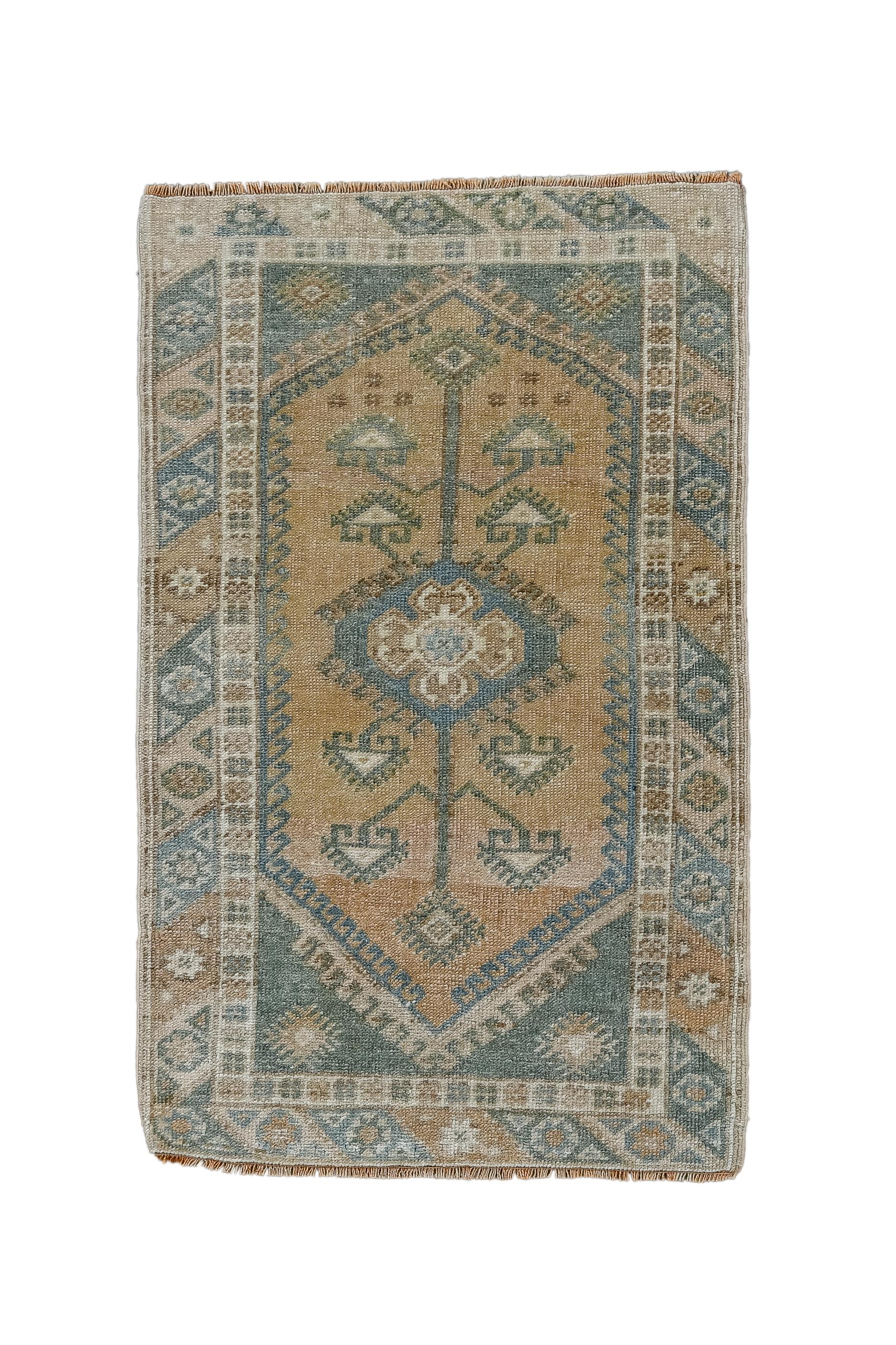This little rustic Anatolian scatter features a rust field with a central medallion, long vertical extenders and eight triangular sprouting blossoms. Slate hooked corners. Characteristic border of rhomboids enclosing octagons and stars. Wool