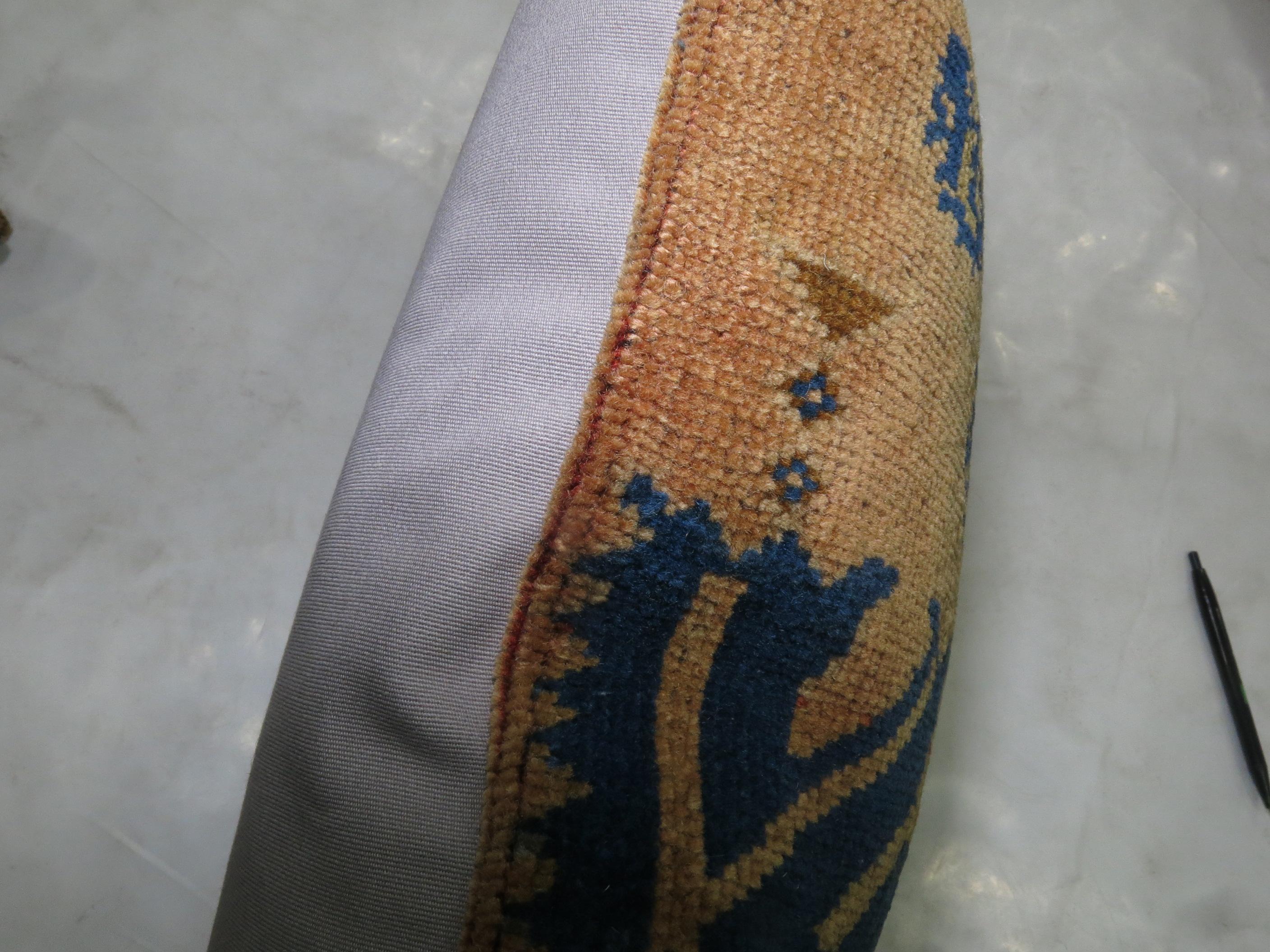 Pillow made from a vintage Turkish Oushak rug in blues and peach.
