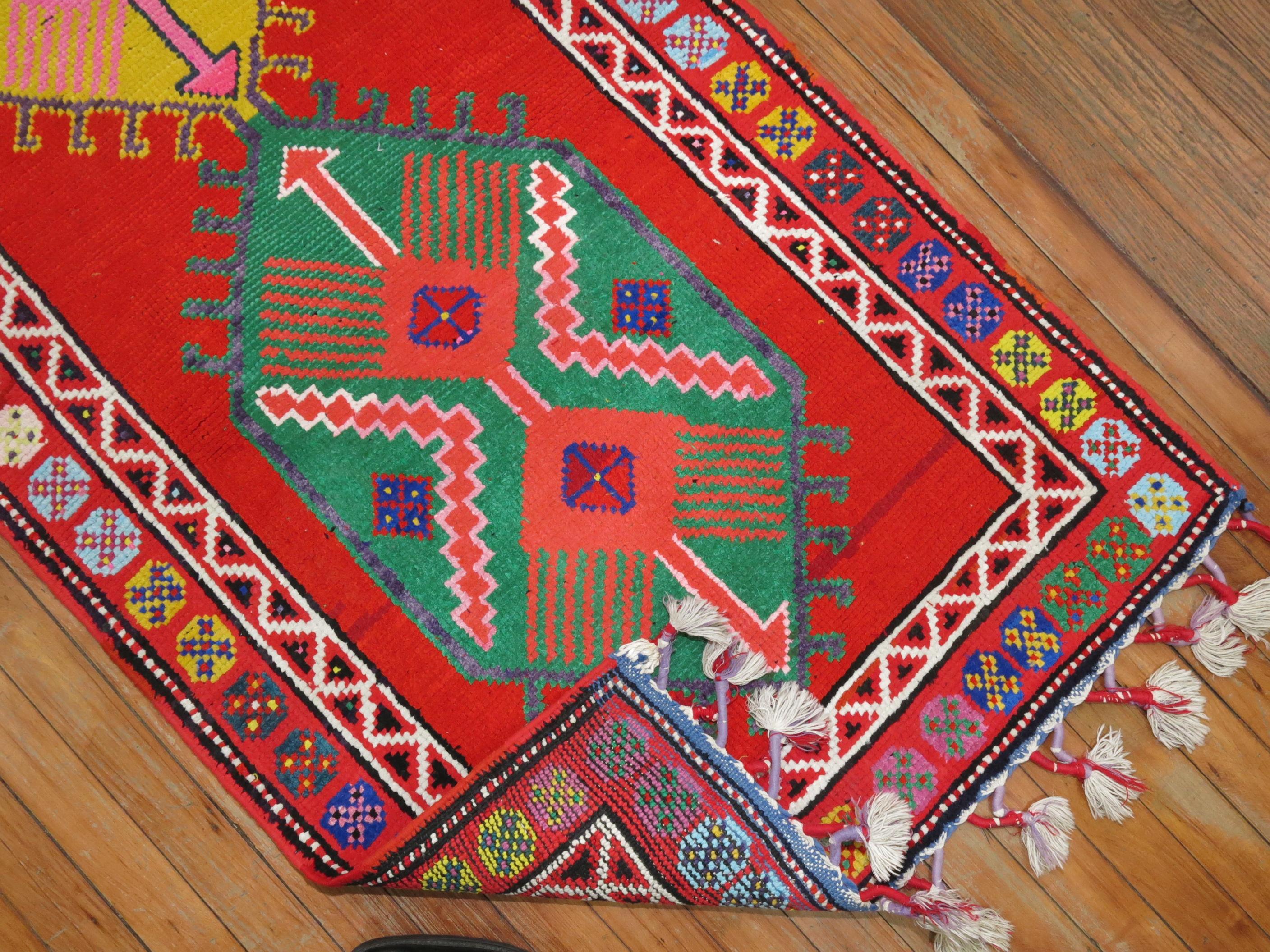 A funky colorful mid-20th century one of a kind Turkish runner woven in central Turkey. The weaver included longer fringes on each side giving it a unique characteristic.