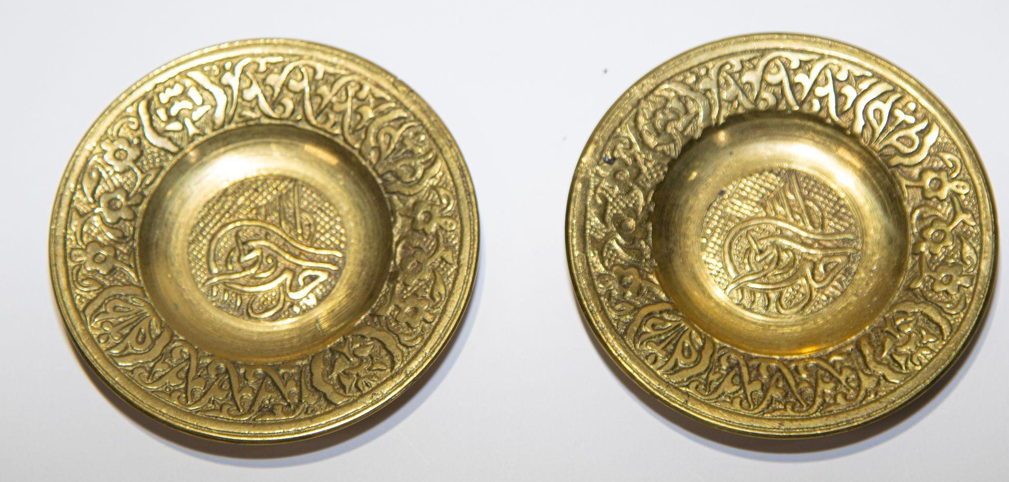 Vintage brass Turkish etched coasters set of two with the Ottoman calligraphic Tughra design in the center.
Handcrafted, embossed and etched design on brass.
Great to use as coasters for your Moroccan or tea glasses or as a collectible brass
