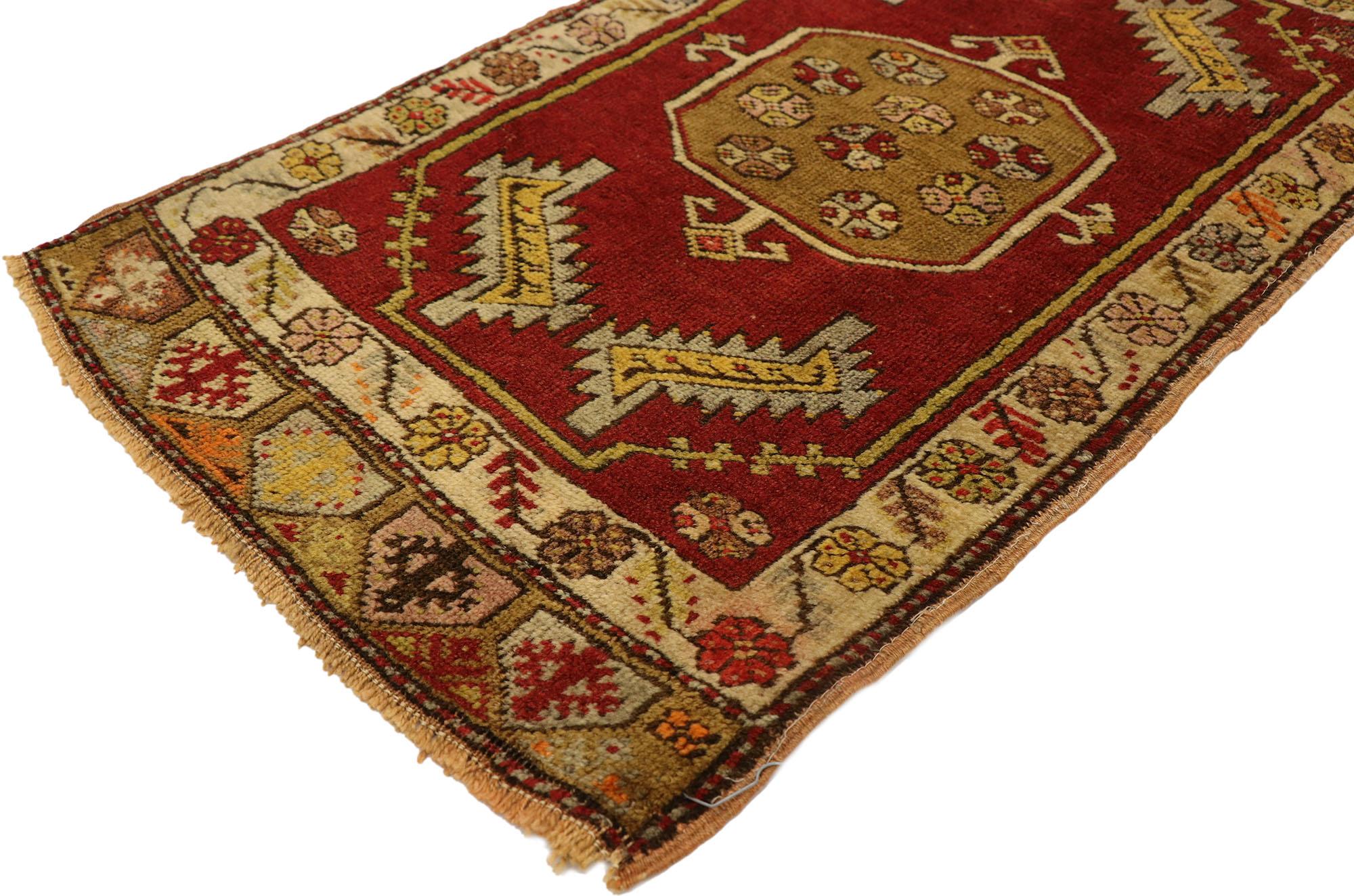 51497 Vintage Turkish Yastik Rug, 01'07 x 02'10. This hand-knotted wool vintage Turkish Yastik rug radiates a warm and inviting charm, reflective of the time-honored craftsmanship of Anatolia. The rug's rich red field sets the stage for a bold