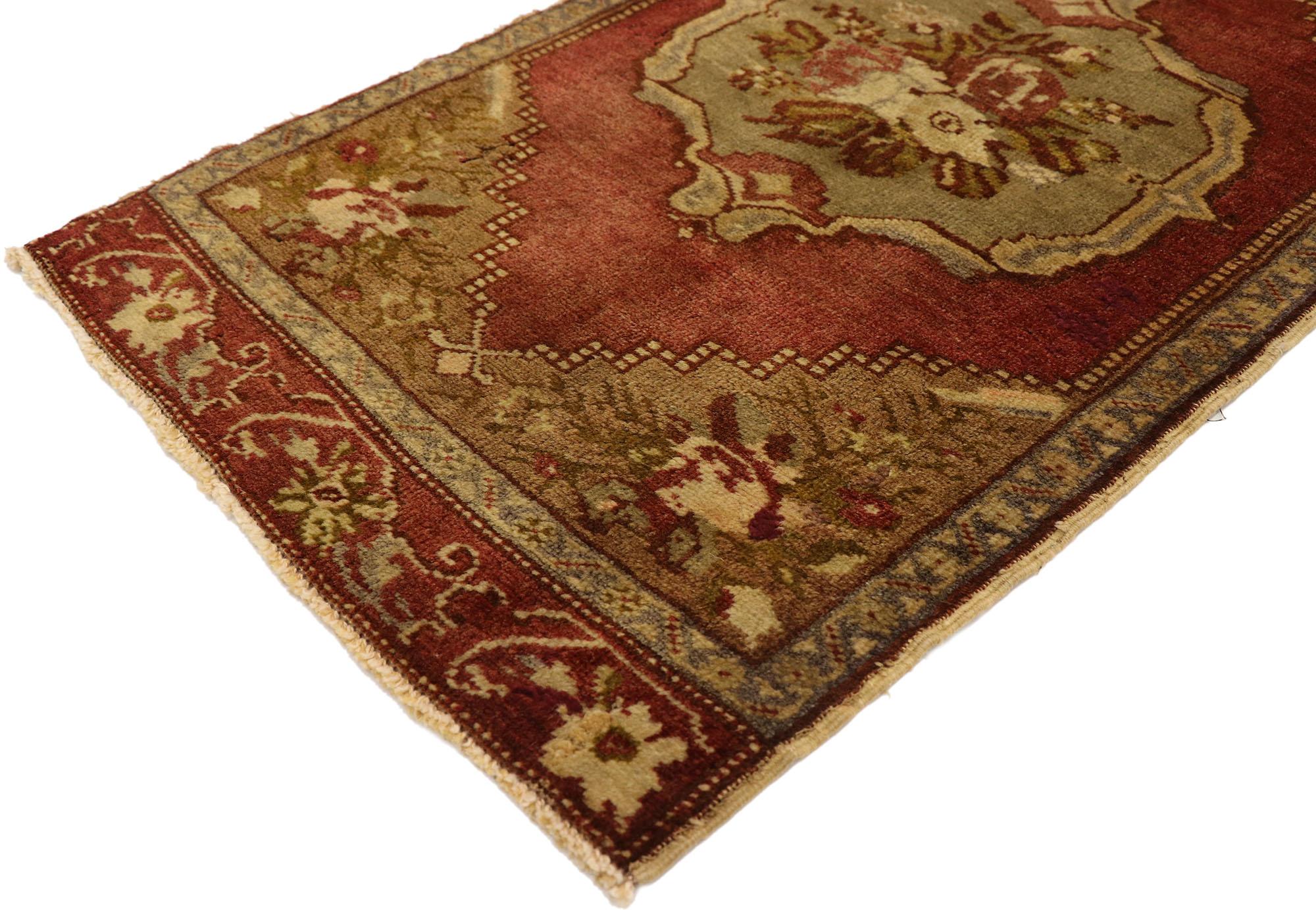 51439 Vintage Turkish Yastik Rug, 01'08 x 03'01. This hand-knotted wool vintage Turkish Yastik rug radiates a romantic and feminine charm with its harmonious blend of rich, earthy tones and intricate floral motifs. At the heart, a central medallion,