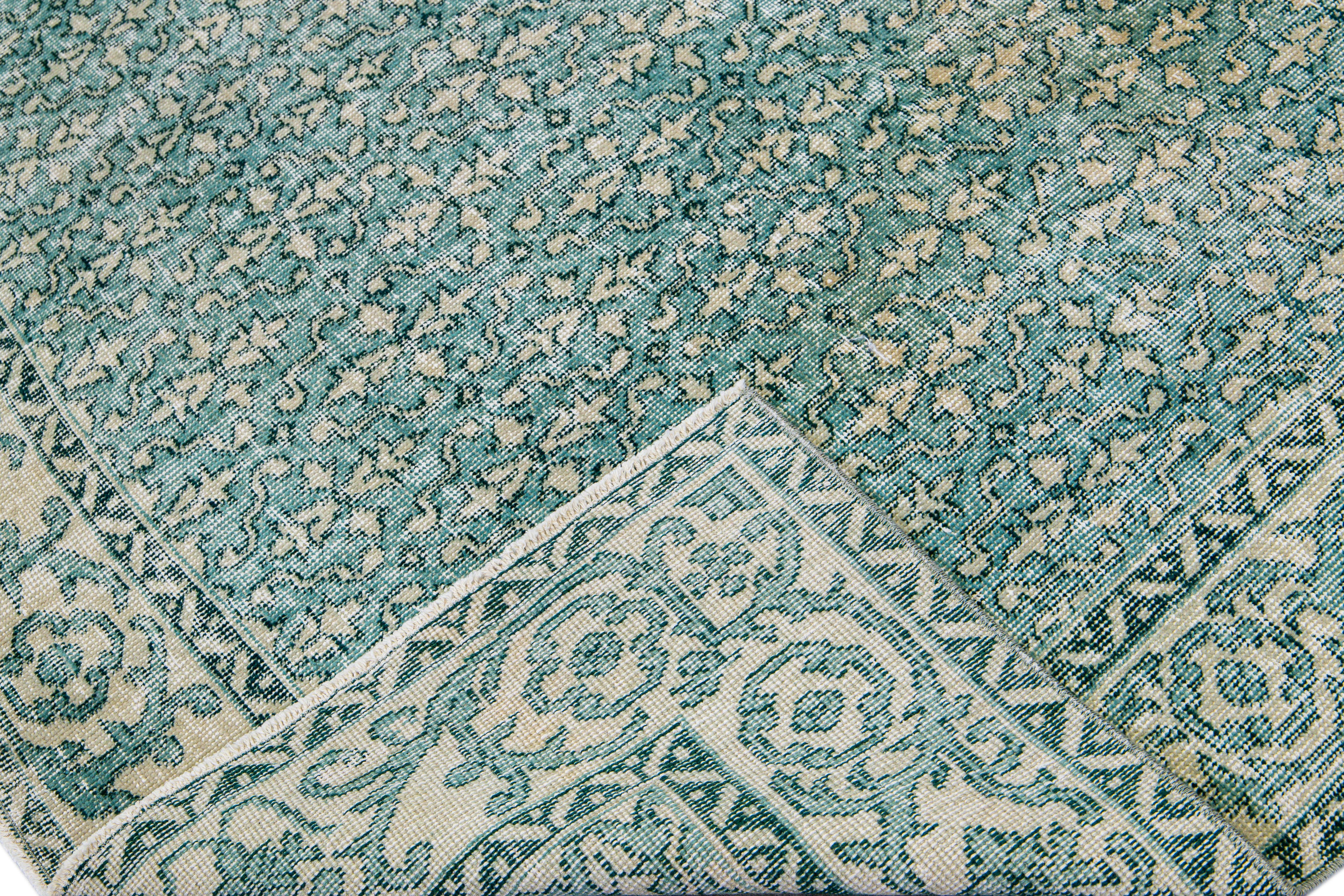 Beautiful vintage Deco Turkish hand-knotted wool rug with a teal field. This Turkish rug has a beige accent in a gorgeous all-over geometric floral pattern design.

This rug measures: 6'8
