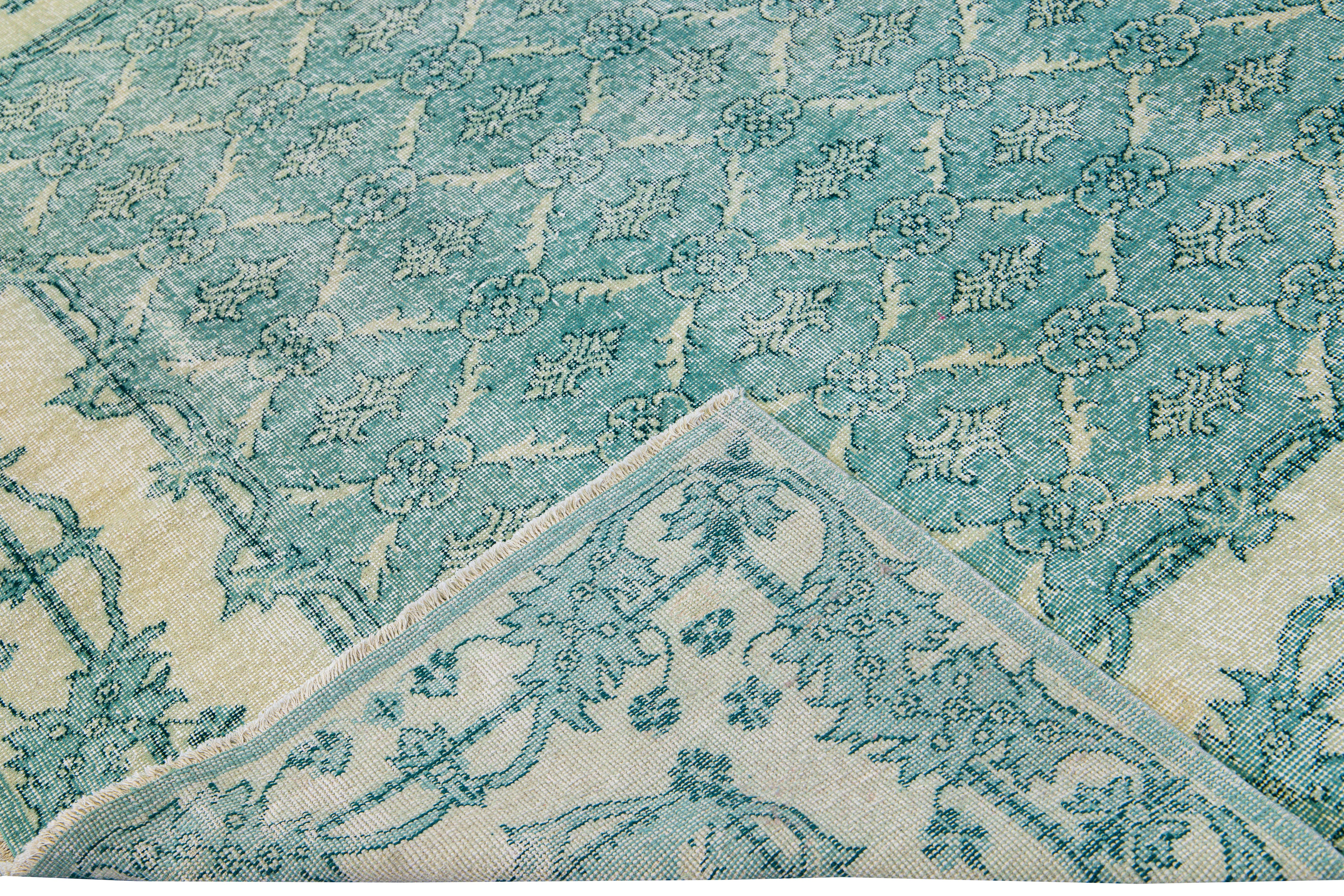Beautiful vintage Deco Turkish hand-knotted wool rug with a teal field. This Turkish rug has a beige accent in a gorgeous all-over geometric floral pattern design.

This rug measures: 6'9