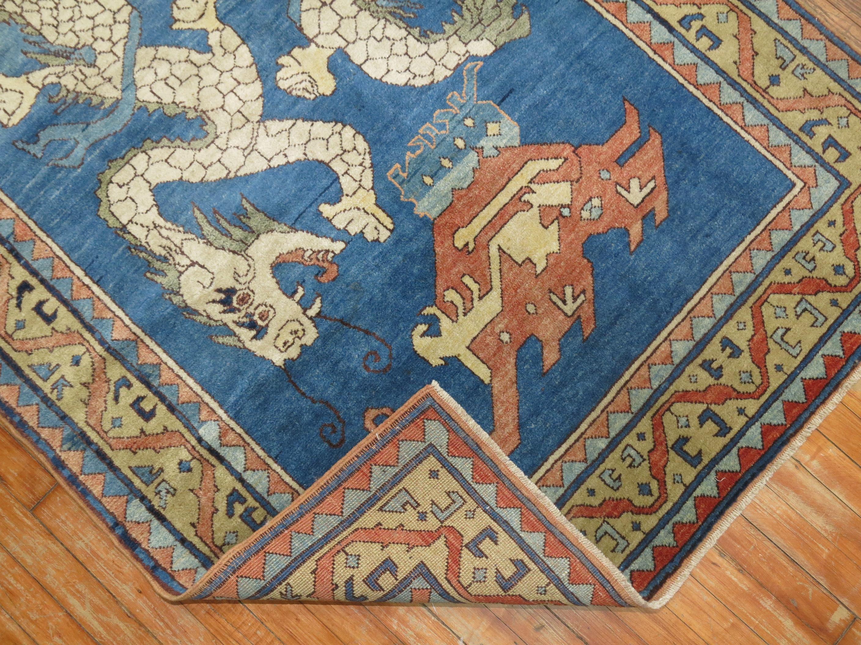 One of a kind late 20th century vintage Turkish rug depicting 2 dragons on a sky blue ground in excellent full pile condition. Handwoven in the Azari village in Central Part of Turkey, most probably derived from a 19th century Chinese rug.