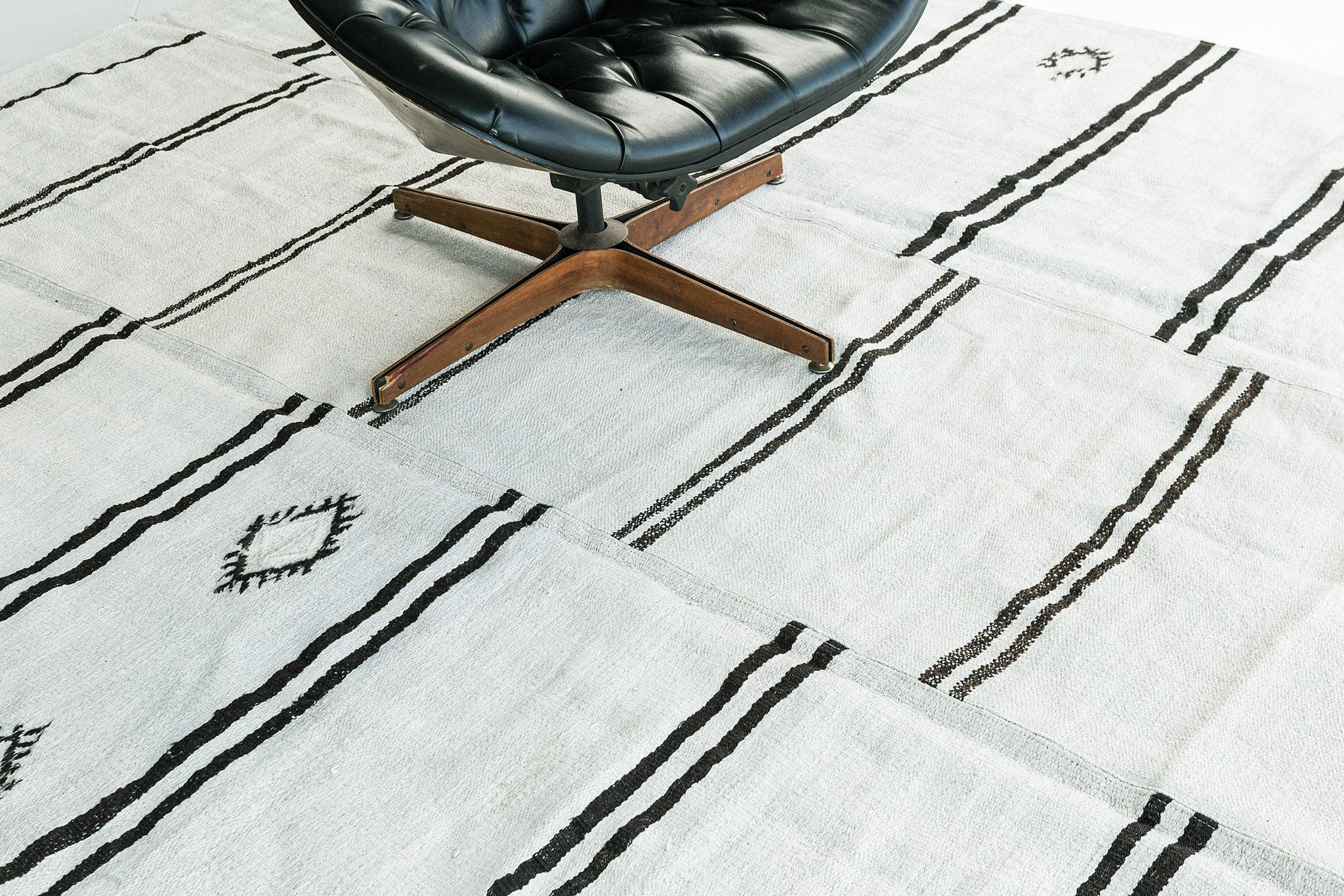 A stunning vintage Turkish Duz banded features asymmetrical black stripes with their symbols. The varying degrees of stripes create a simple yet interesting design for a wide variety of interiors. Excellent decorative art for your home spaces.

Rug