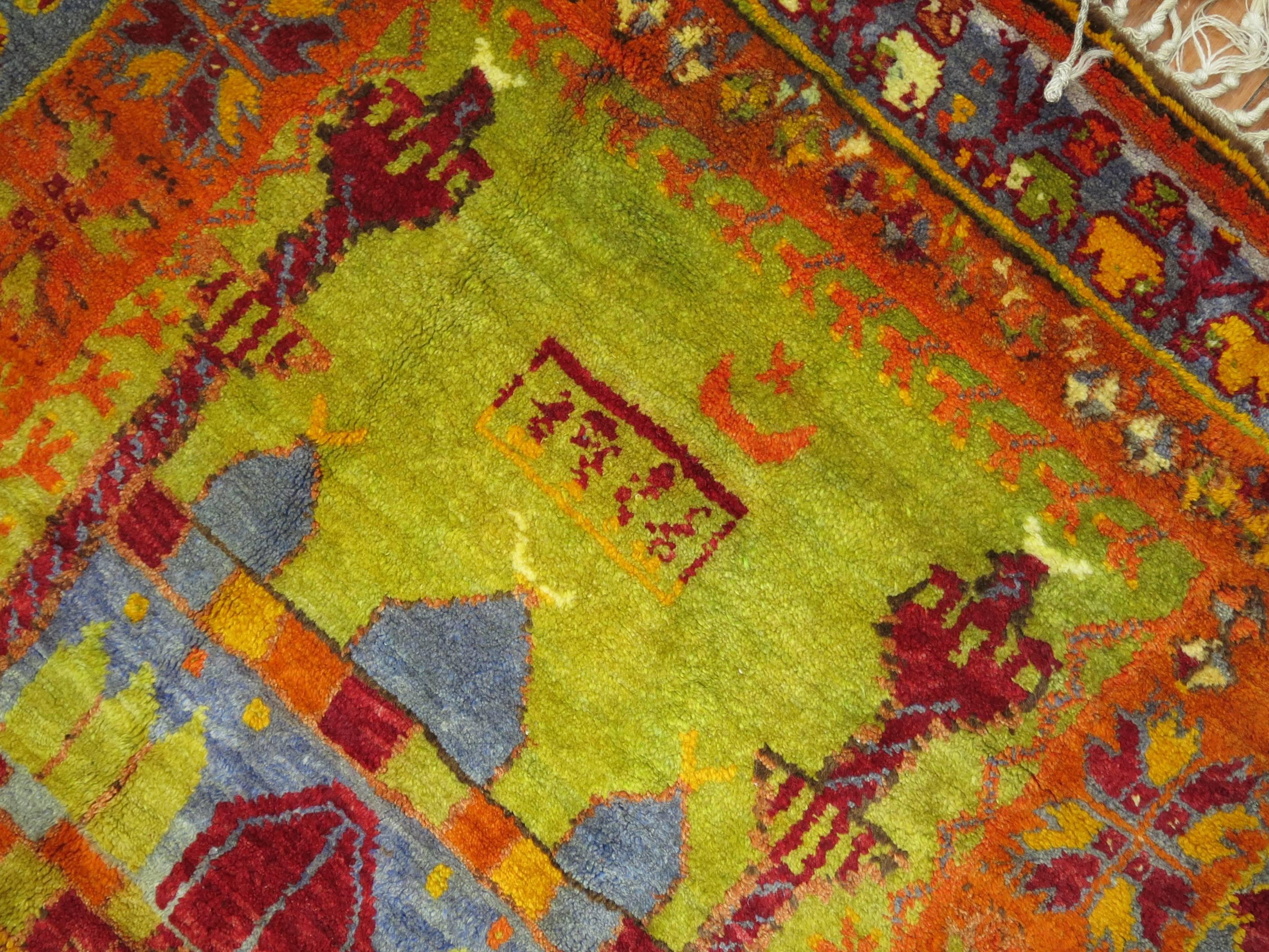 An eclectic Turkish Anatolian intermediate size of runner with a flashy array of electric colors and an abstract design.
