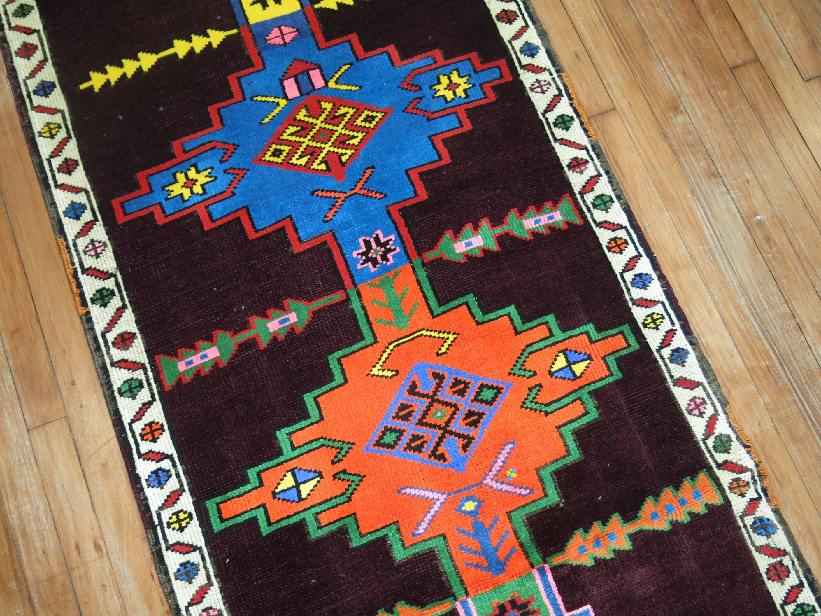 An eclectic Turkish Anatolian runner with a flashy array of electric colors and geometric all-over design.