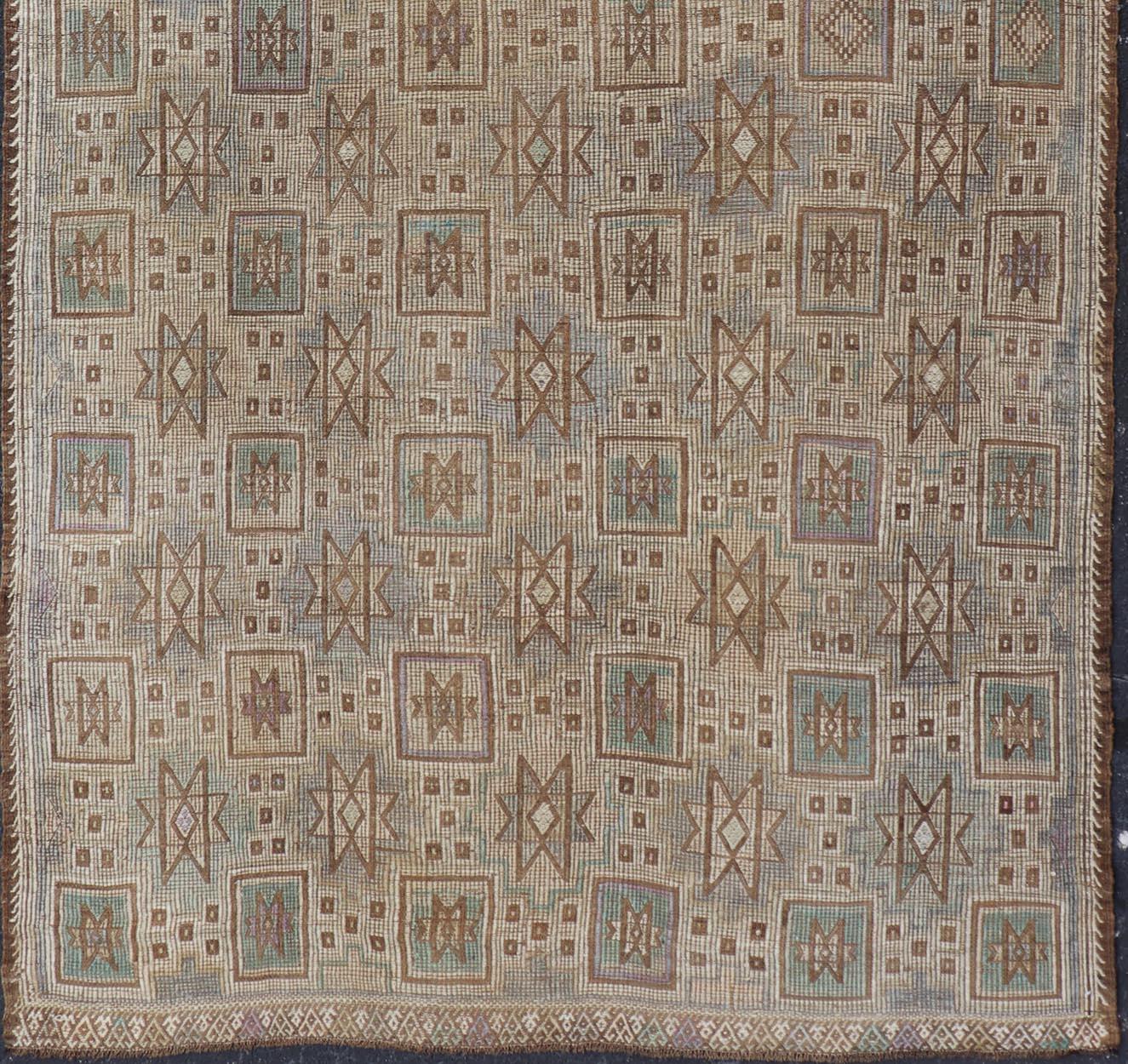 Measures: 5'0 x 9'8 

This vintage flat weave Kilim was hand woven in Turkey during the 1950's. The light taupe field is decorated with tribal-like motifs, with light teal, lavender and mocha color palette. 

Country of origin: Turkey; type: