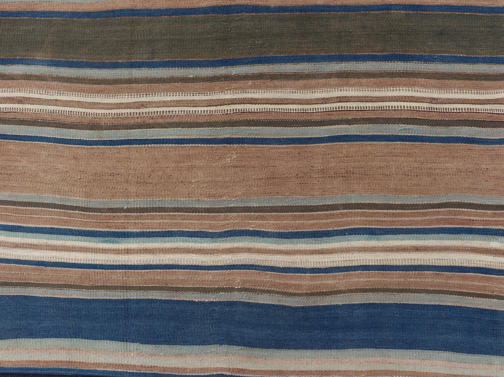Vintage Turkish flat-weave Kilim with blue's, brown, & taupe in striped design. Keivan Woven Arts / rug EN-P13682, country of origin / type: Turkey / Kilim, circa Mid-20th Century.

This Turkish Kilim flat-woven is perfectly suited for a variety