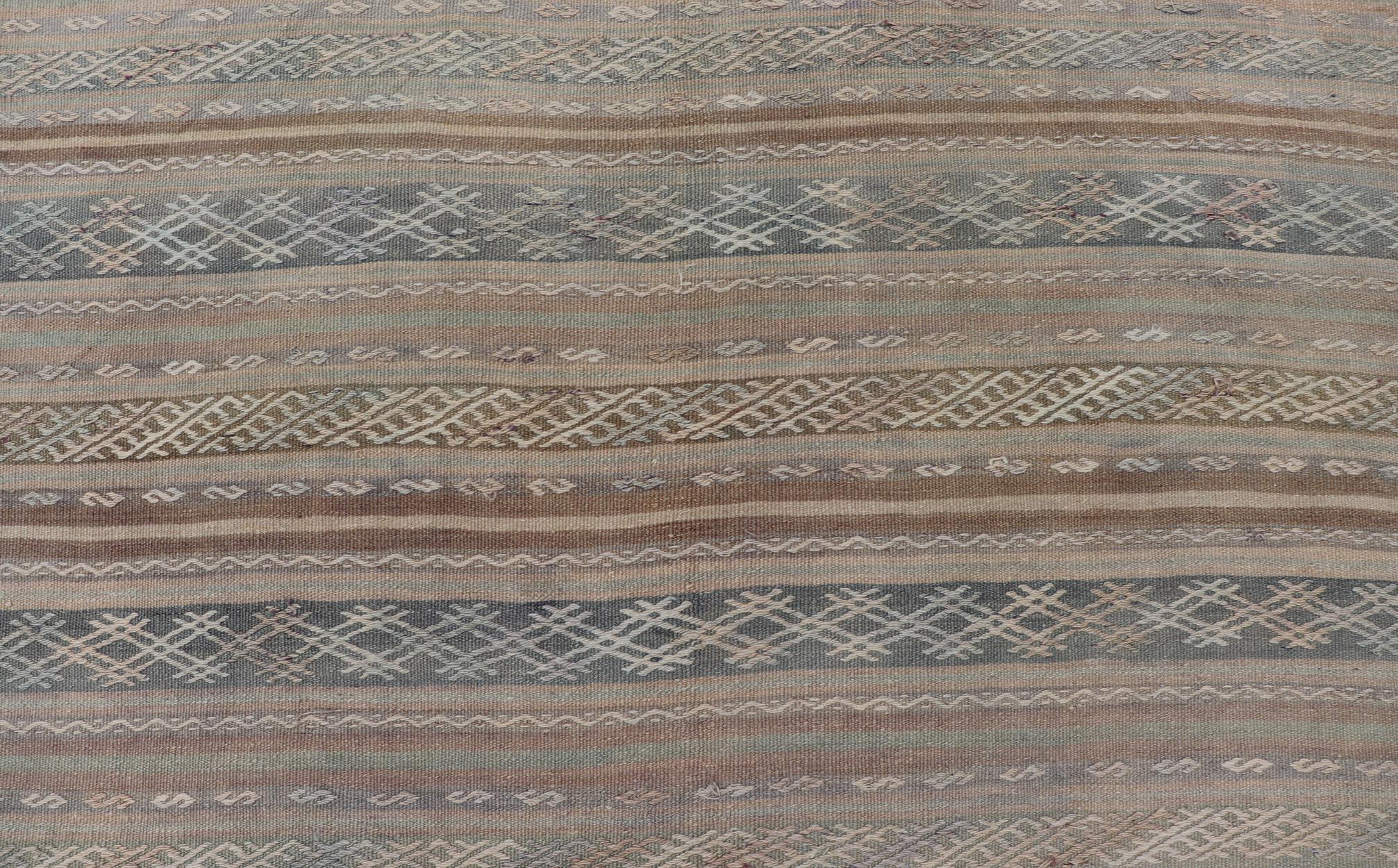 Vintage Turkish Flat-Weave Kilim with Embroideries in Muted Tones and Stripes. Keivan Woven Arts / rug EN-15180, country of origin / type: Turkey / Kilim, circa 1950
Measures: 5'2 x 8'3 
This vintage Turkish Kilim rug features a contemporary