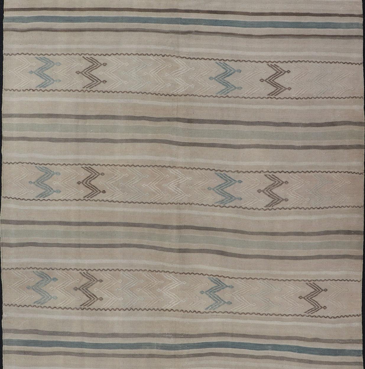 Minimalist design Kilim from light blue, brown, and taupe Turkey, Keivan Woven Arts / rug/EN-179456, country of origin / type: Turkey / Kilim, circa 1950

This vintage flat-woven Kilim features a minimalist design rendered in thin brown, light blue,