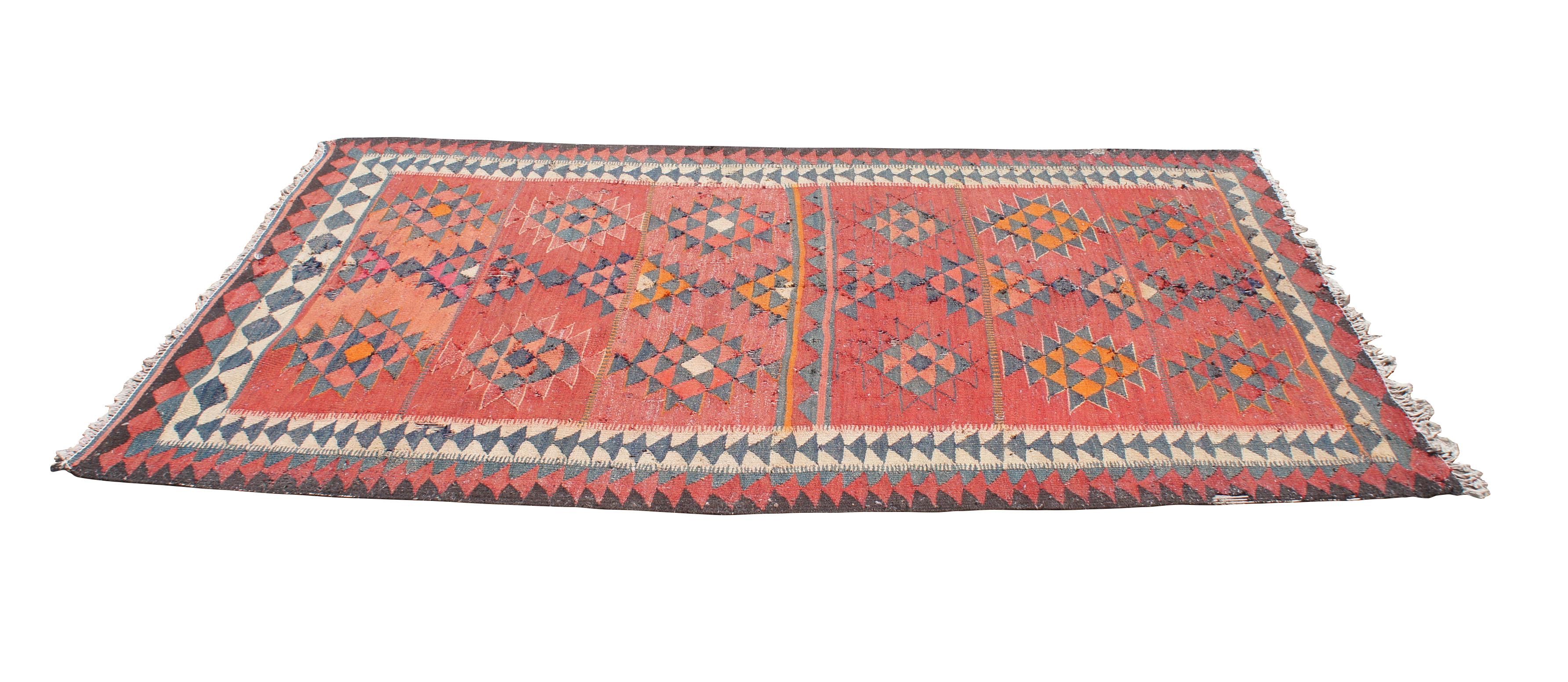 A colorful Turkish kilim rug runner from the second half of the 20th century.  Made from wool in Oushak (western) Turkey.  Features a geometric pattern in red, blue orange and beige.  Ushaks are flat-woven rugs that are on the thinner side of the