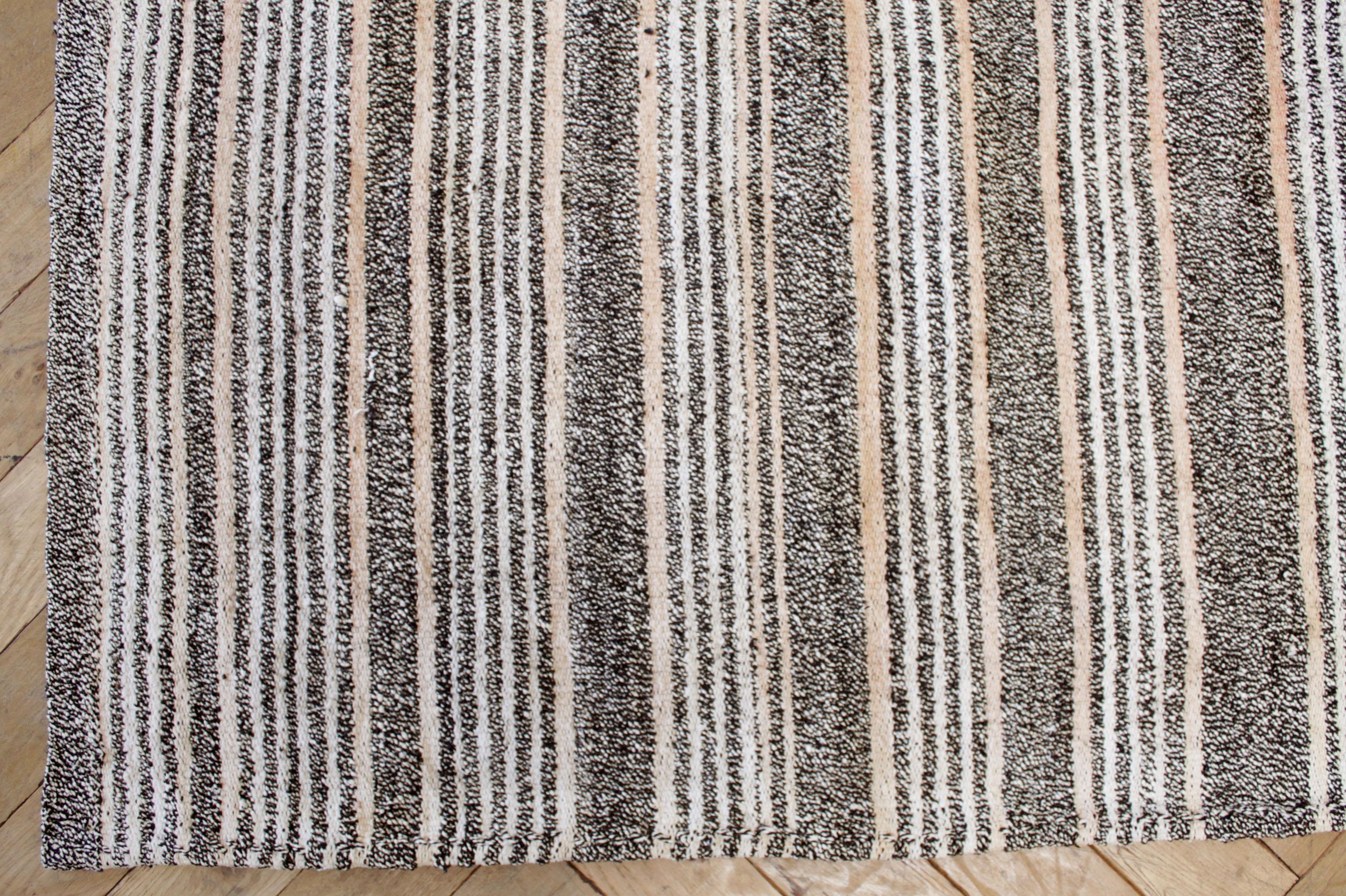 Ramy rug
Vintage Turkish rug in brown with white weave and creamy white stripes, with dark brown stripes, with subtle shades of a light coral color stripe.
   
Flat-weave, wool and goat hair, make these extremely durable with great use for high