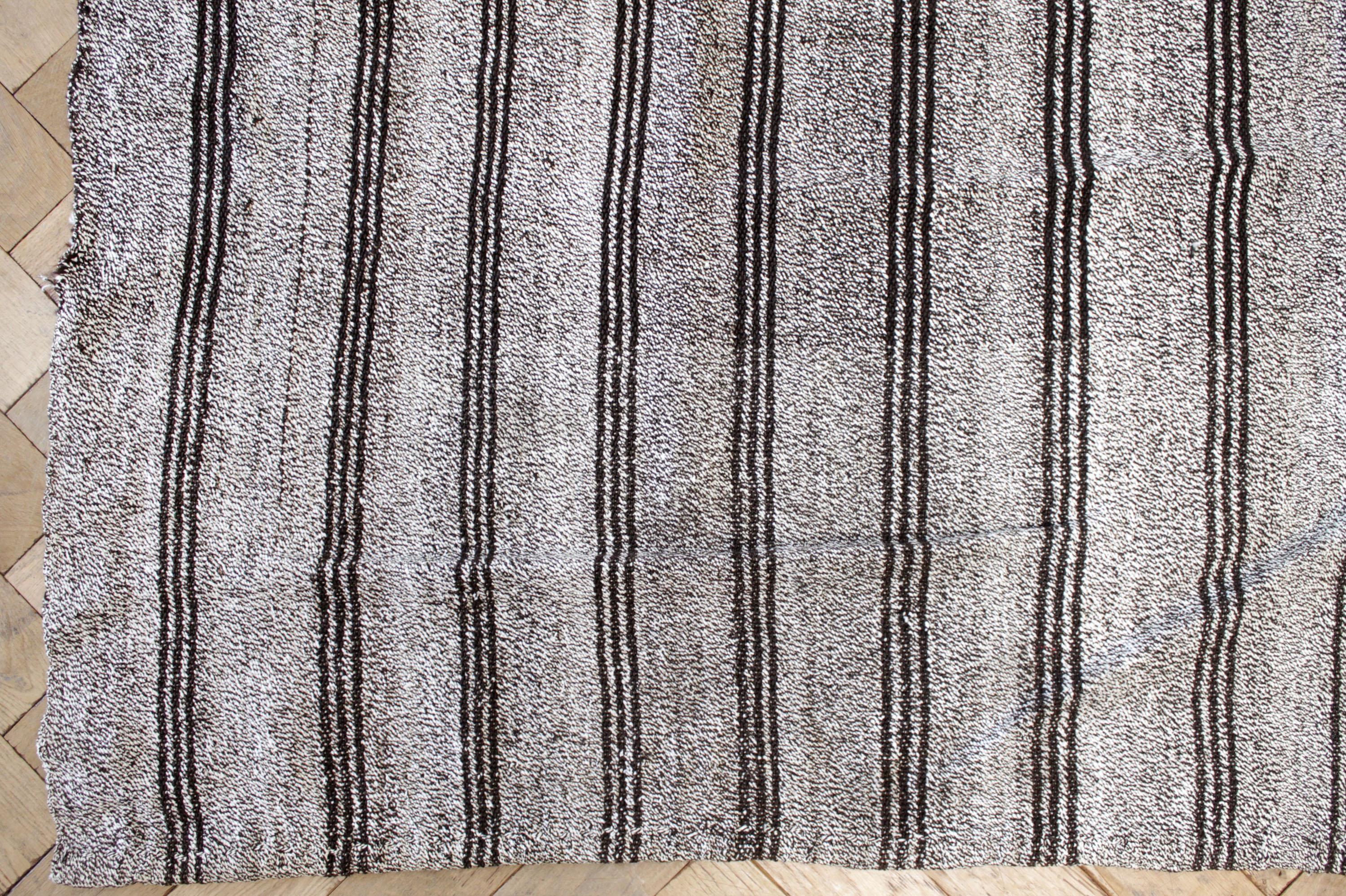 Daria rug
Vintage Turkish rug in brown with white weave and creamy white stripes, with dark brown stripes.

Flat-weave, wool and goat hair, make these extremely durable with great use for high traffic areas. This item has been cleaned, and is