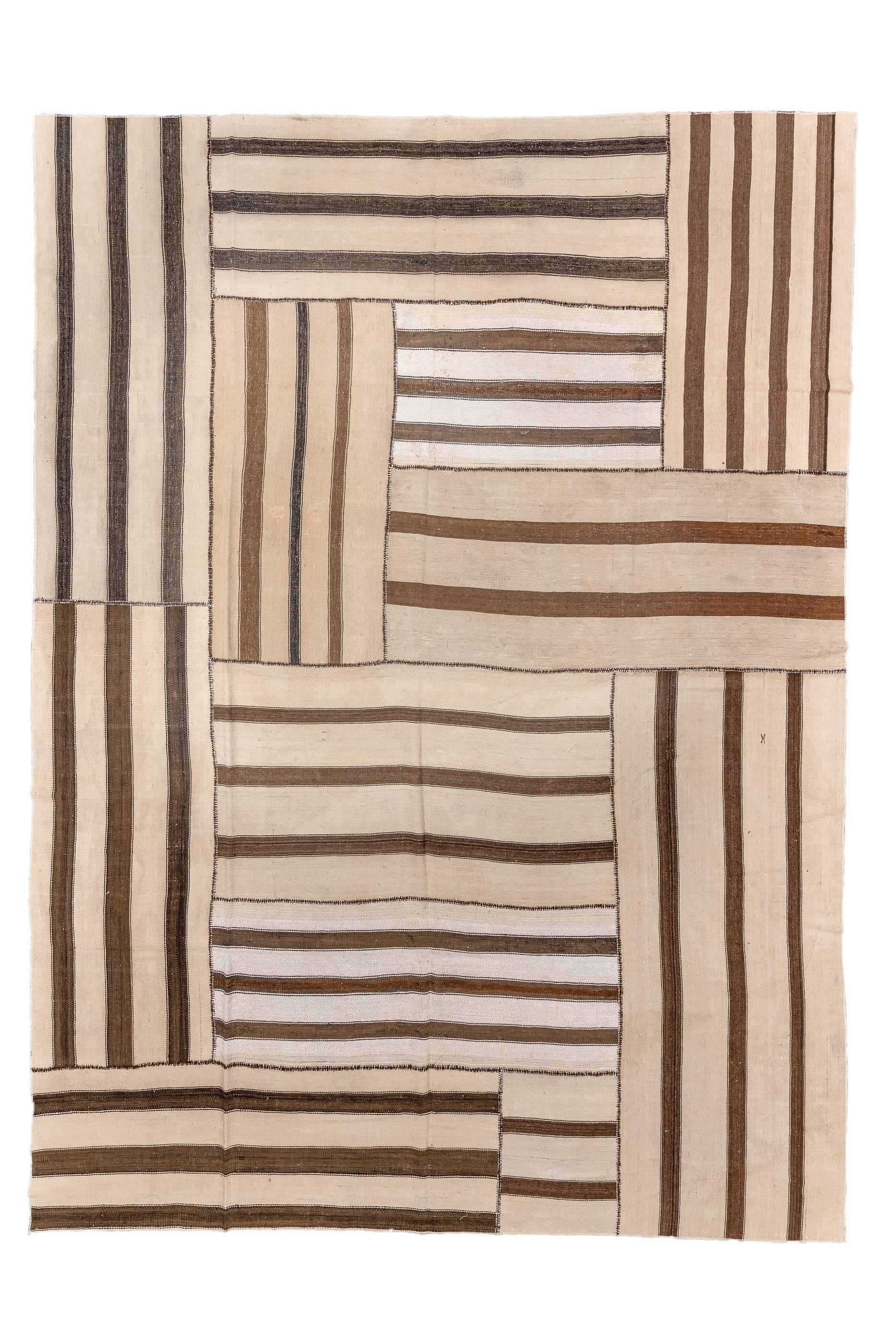 The ecru field is broken up into up and down partial length panels accented in darkest brown stripes. A rectangle is formed by swirling bitonal panels in the upper half. The panels have two to four dark brown stripes each. The dimensions are