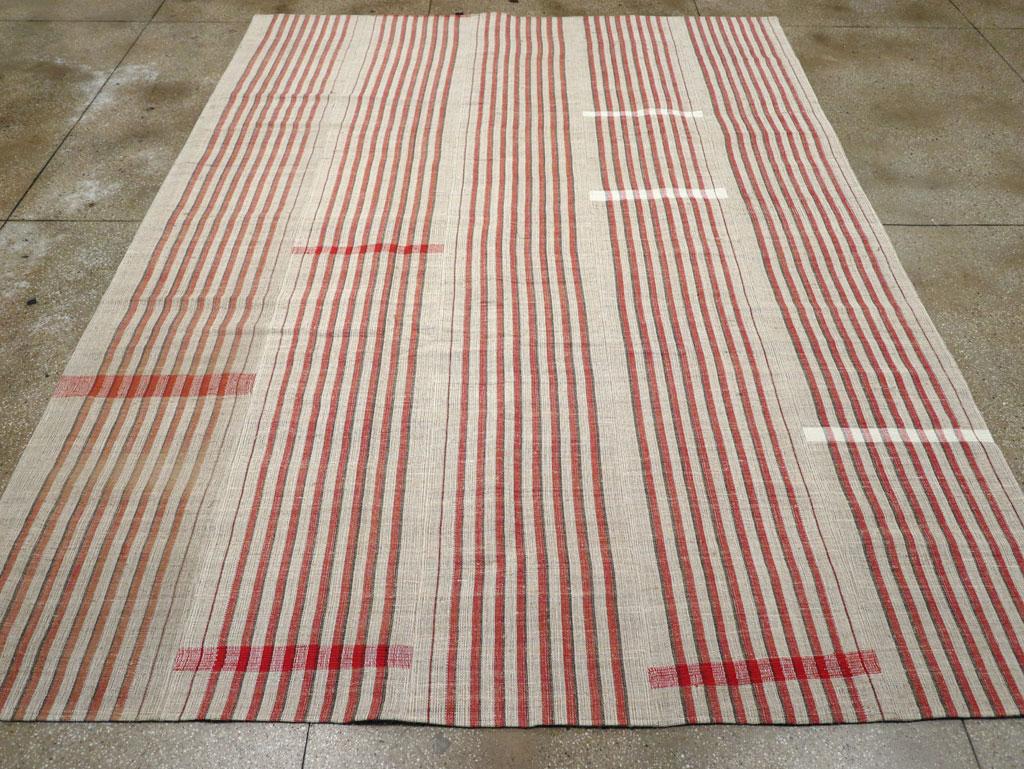 This mid-20th century Turkish flatweave Kilim rug, measuring 9' 2