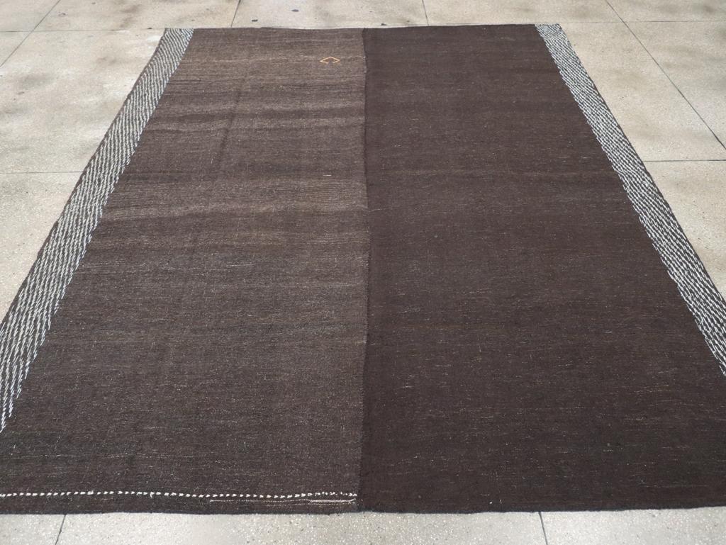 This mid-20th century Turkish flatweave Kilim rug, measuring 9' 6