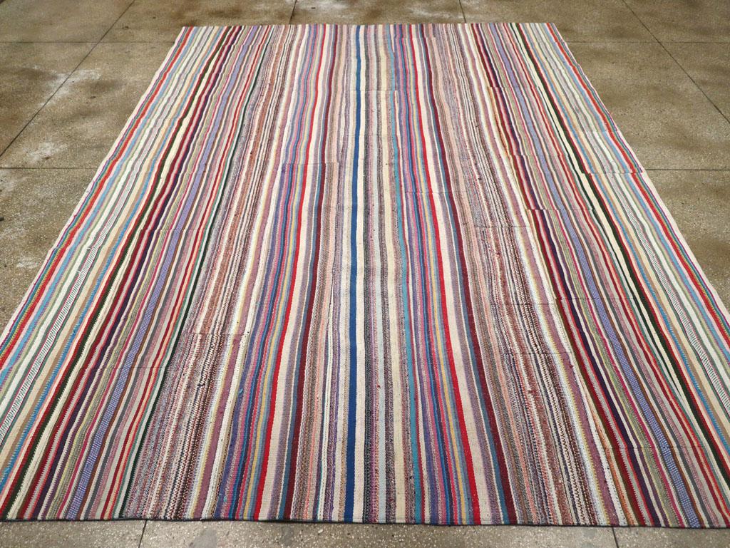 This mid-20th century Turkish flatweave Kilim rug, measuring 9' 11