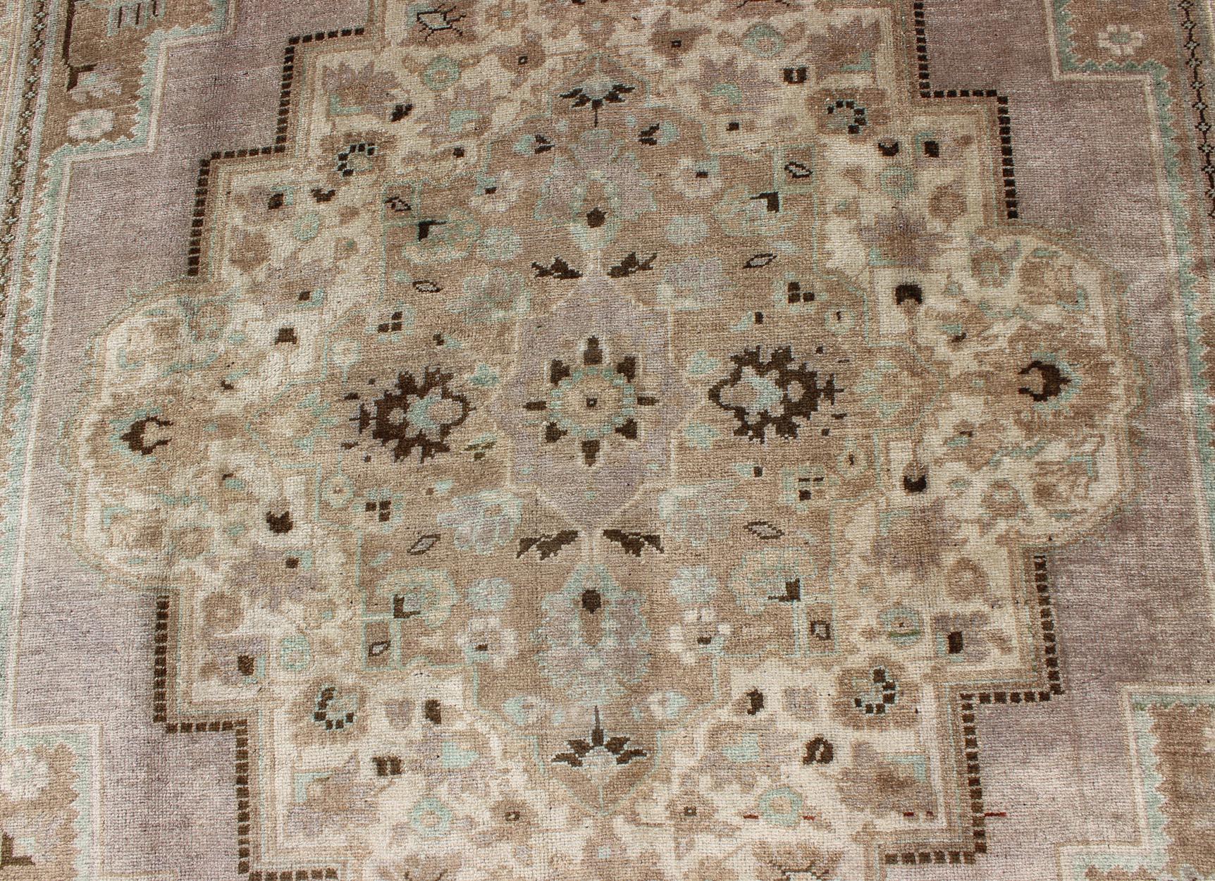 Mid-20th Century Vintage Turkish Floral Medallion Oushak in Earth Tones, Lavender, and Ice Blue For Sale
