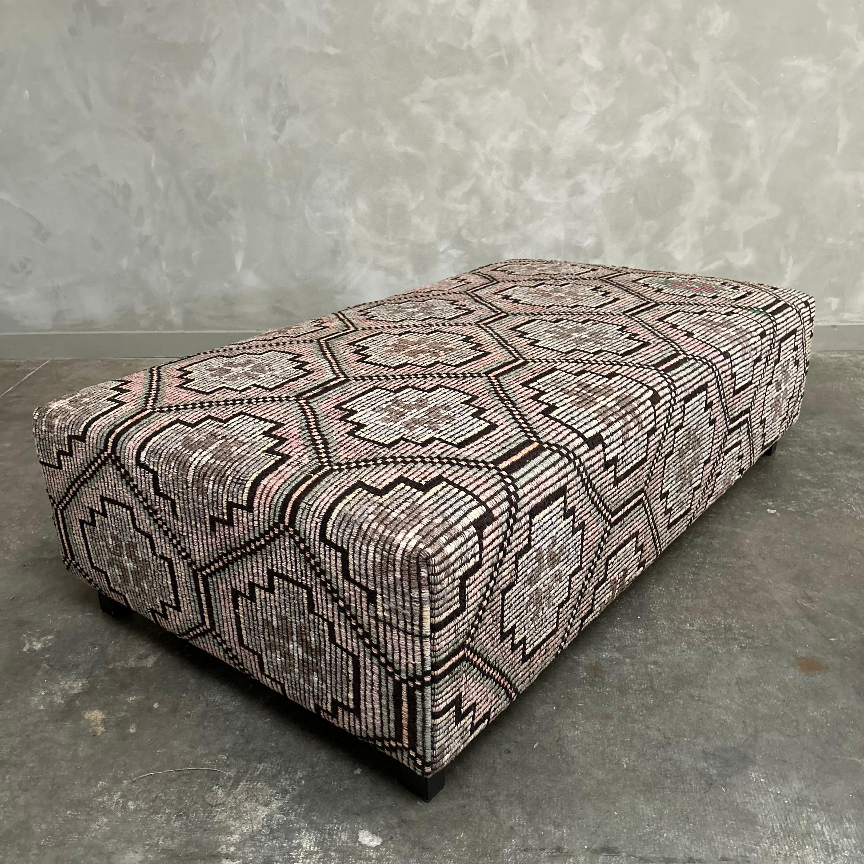 Beautiful Custom Made Cube ottoman made from a vintage Turkish hemp and wool rug, in brown, yellow, faded rose, pink, grays, taupes with charcoal colorings. Original seams, sewn with an overlock under to prevent any splitting of seams. HR foam,
