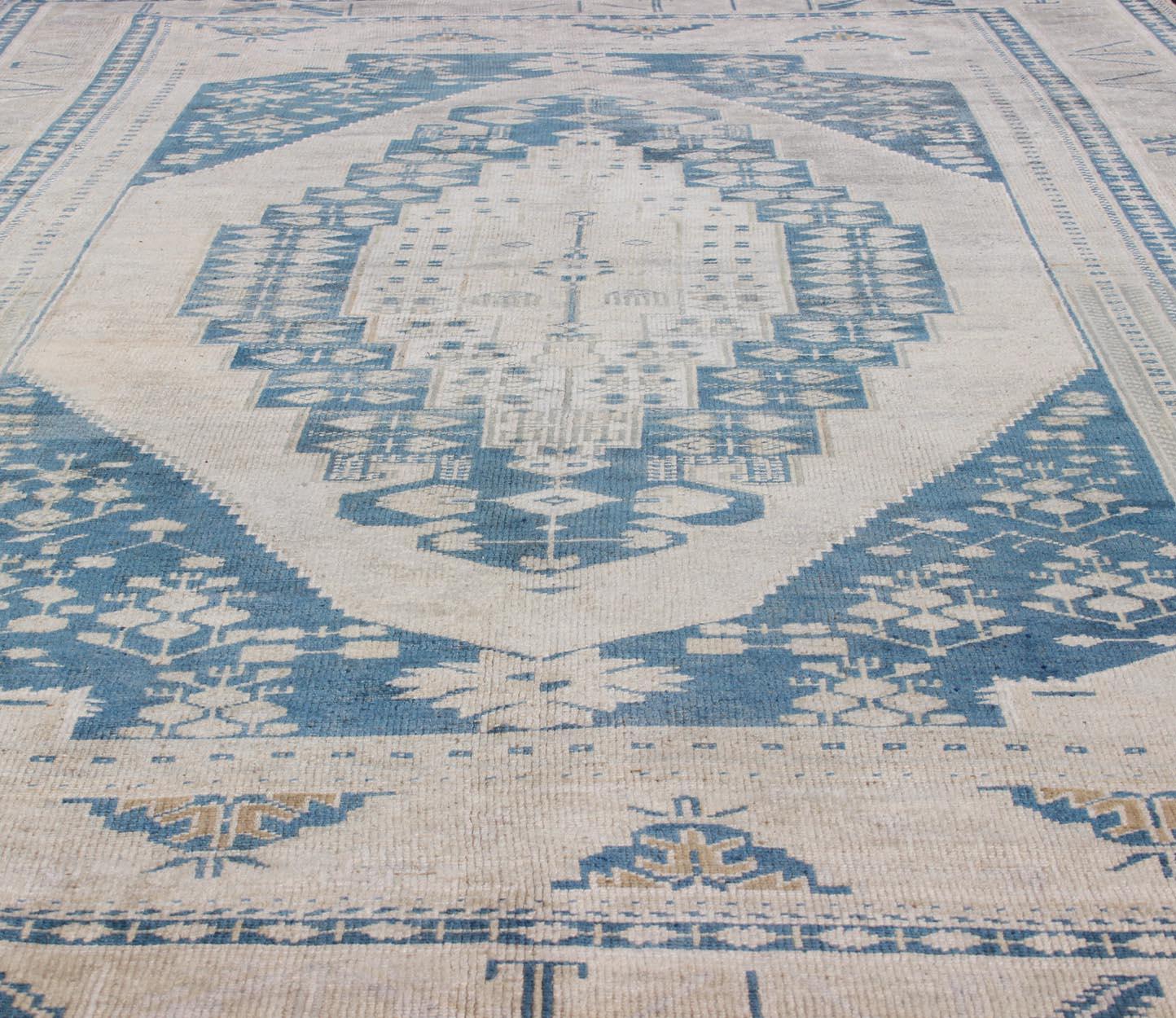 Wool Vintage Turkish Hand Knotted Oushak Rug with Central Medallion in Blue and Cream For Sale